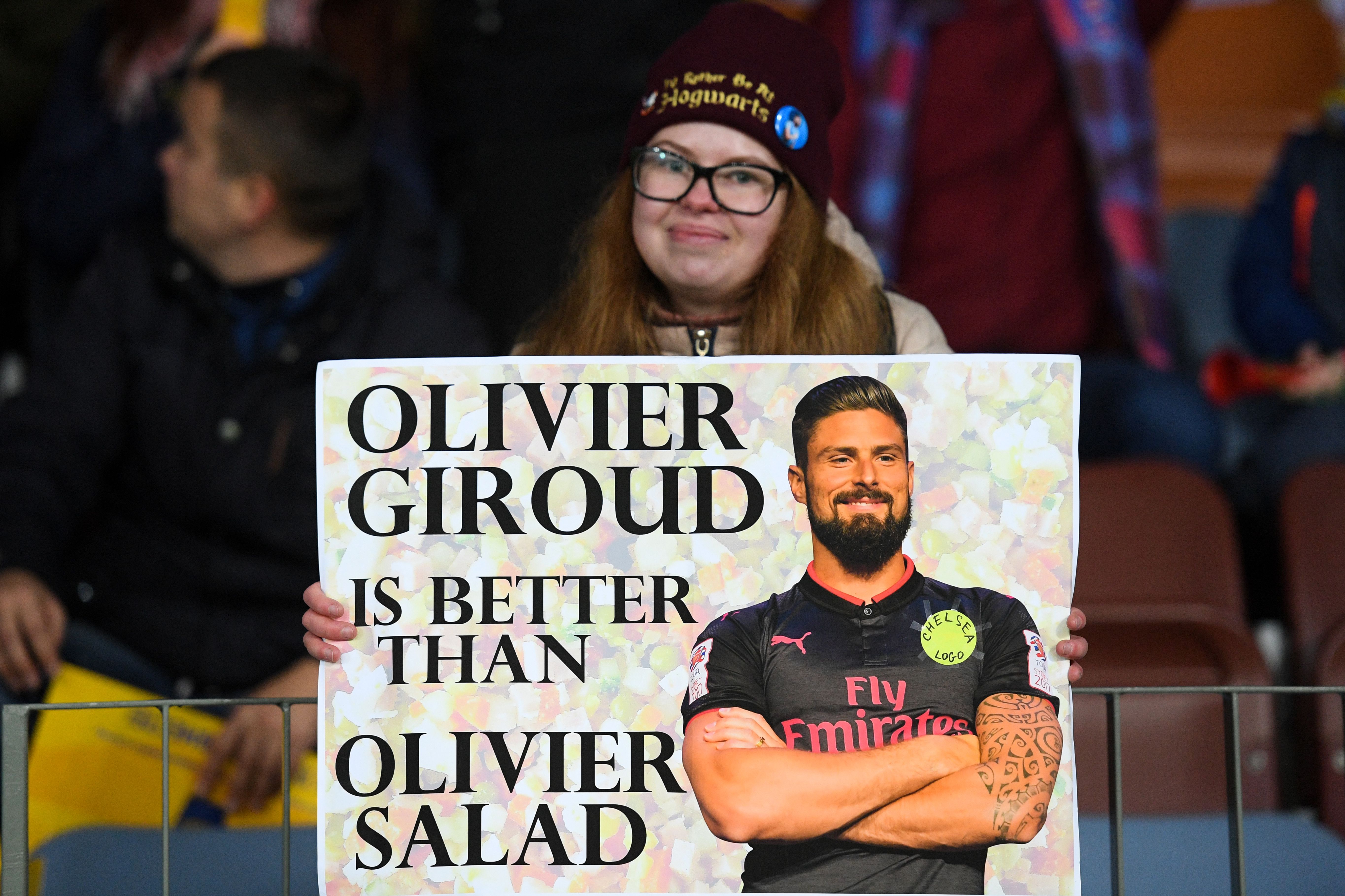 A Chelsea supporter poses with a placard with an image of Chelsea's French striker Olivier Giroud before the UEFA Europa League group L football match between FC BATE Borisov and Chelsea FC in Borisov outside Minsk on November 8, 2018. (Photo by Kirill KUDRYAVTSEV / AFP)        (Photo credit should read KIRILL KUDRYAVTSEV/AFP/Getty Images)