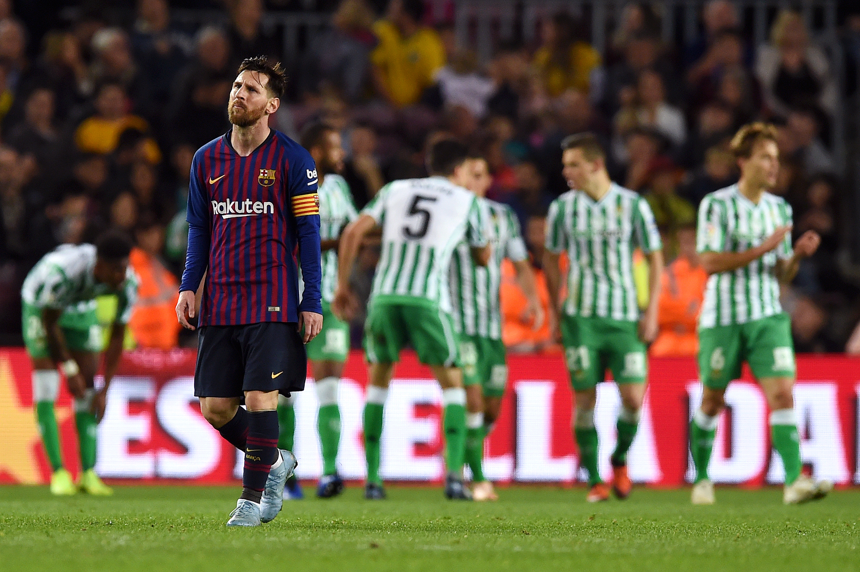 BARCELONA, SPAIN - NOVEMBER 11: Lionel Messi of Barcelona looks dejected as the Real Betis players celebrate their sides fourth goal during the La Liga match between FC Barcelona and Real Betis Balompie at Camp Nou on November 11, 2018 in Barcelona, Spain.  (Photo by Alex Caparros/Getty Images)
