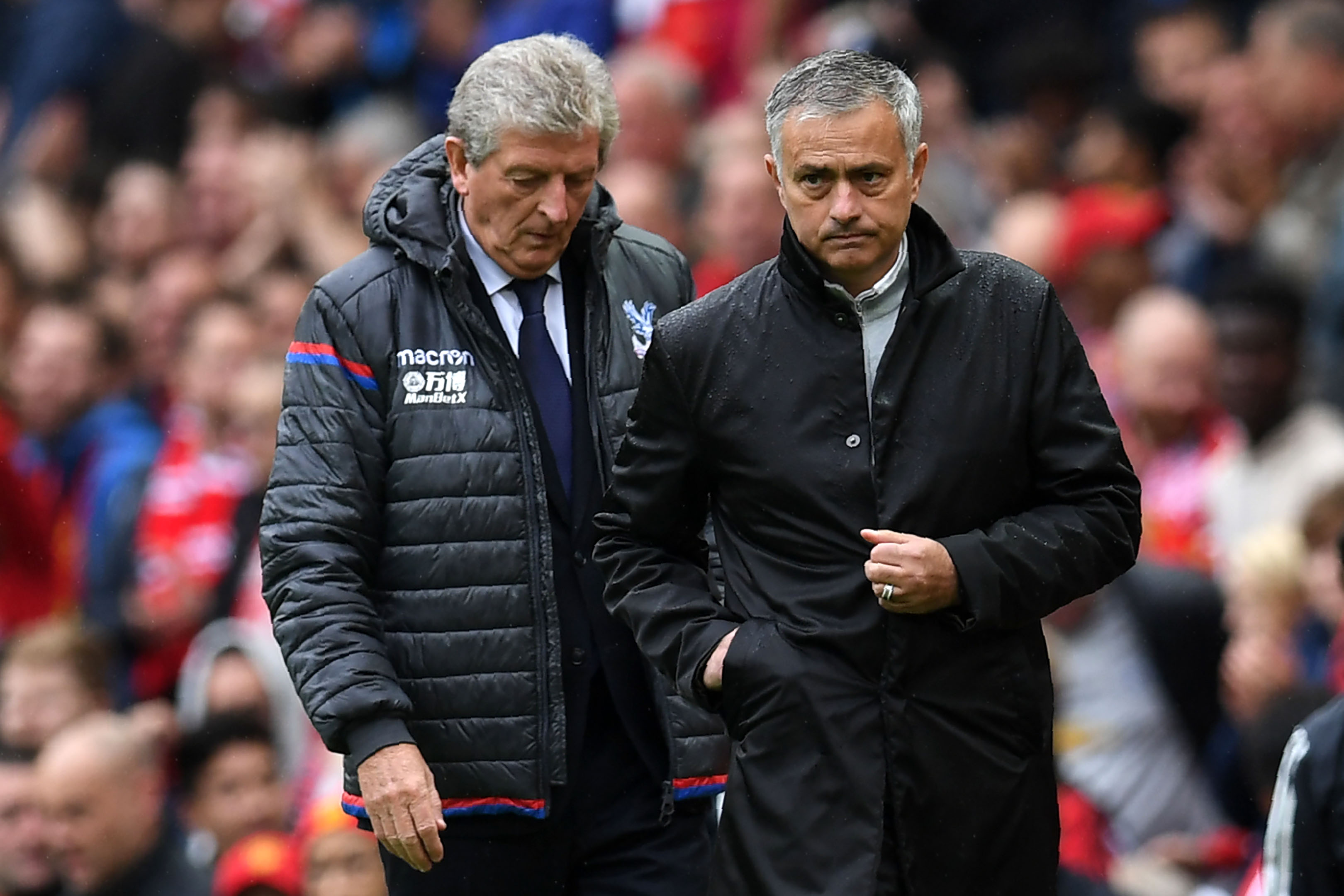 Crystal Palace's English manager Roy Hodgson (L) walks with Manchester United's Portuguese manager Jose Mourinho during the English Premier League football match between Manchester United and Crystal Palace at Old Trafford in Manchester, north west England, on September 30, 2017. / AFP PHOTO / Paul ELLIS / RESTRICTED TO EDITORIAL USE. No use with unauthorized audio, video, data, fixture lists, club/league logos or 'live' services. Online in-match use limited to 75 images, no video emulation. No use in betting, games or single club/league/player publications.  /         (Photo credit should read PAUL ELLIS/AFP/Getty Images)