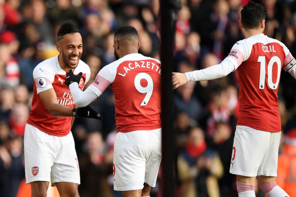 LONDON, ENGLAND - DECEMBER 22: Pierre-Emerick Aubameyang of Arsenal celebrates after scoring his team's second goal with Alexandre Lacazette of Arsenal and Mesut Ozil of Arsenal during the Premier League match between Arsenal FC and Burnley FC at Emirates Stadium on December 22, 2018 in London, United Kingdom. (Photo by Shaun Botterill/Getty Images)