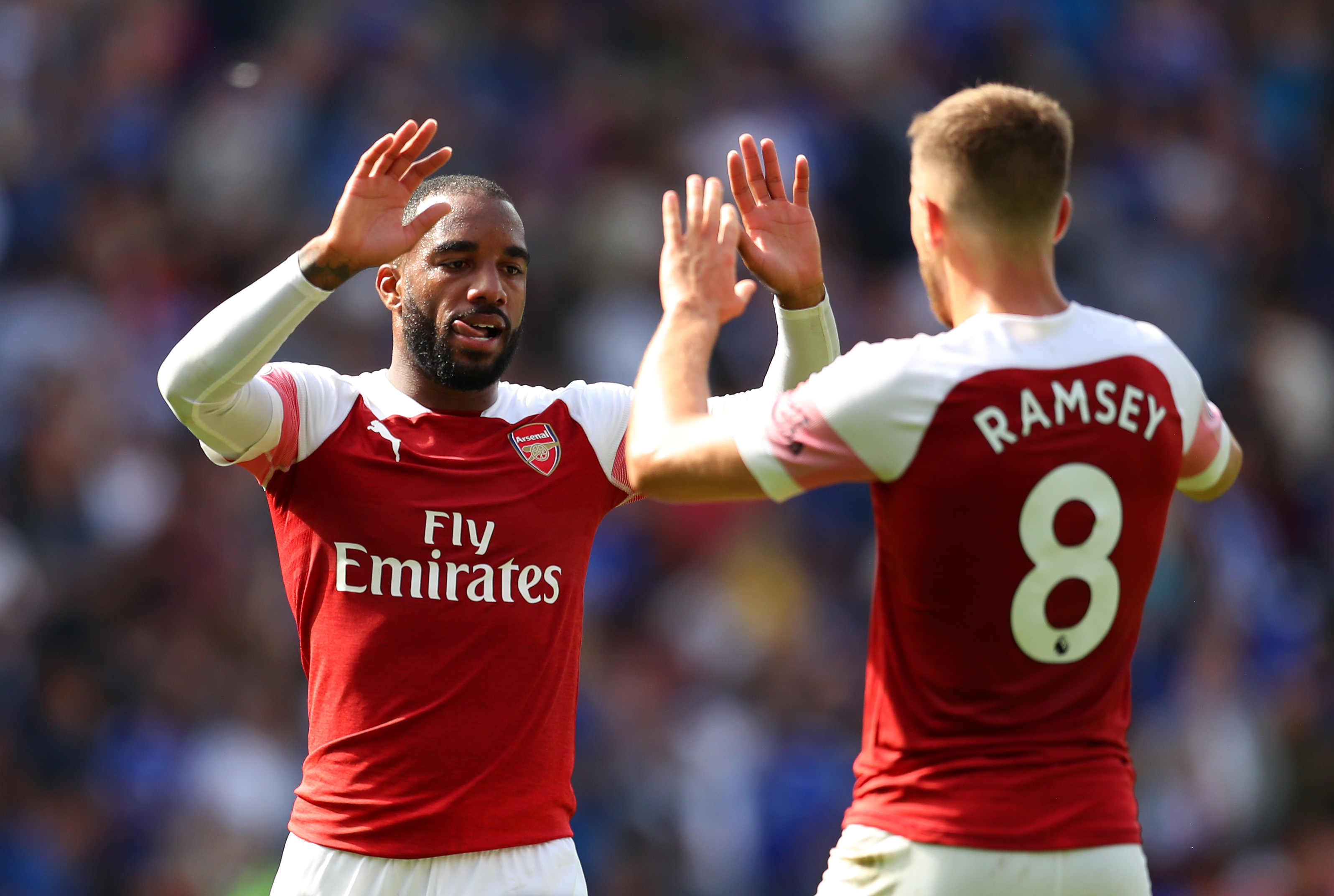 CARDIFF, WALES - SEPTEMBER 02:  Alexandre Lacazette and Aaron Ramsey of Arsenal celebrate victory after the Premier League match between Cardiff City and Arsenal FC at Cardiff City Stadium on September 2, 2018 in Cardiff, United Kingdom.  (Photo by Catherine Ivill/Getty Images)