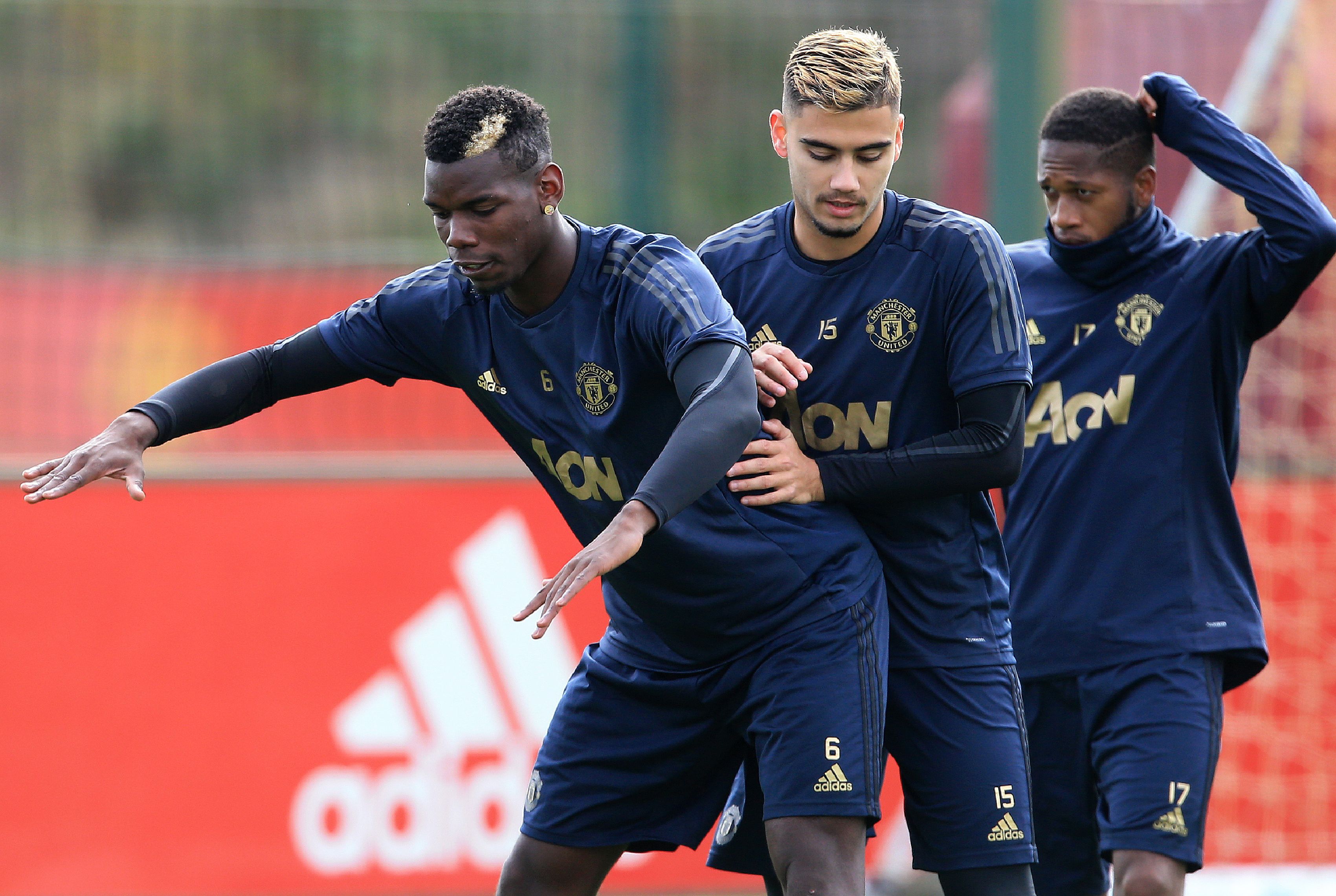 Manchester United's French midfielder Paul Pogba (L) jokes with Manchester United's Belgian-born Brazilian midfielder Andreas Pereira (C) during a training session at the Carrington Training complex in Manchester, north west England on October 1, 2018, ahead of their Champions League group H football match against Valencia on October 2. (Photo by Lindsey Parnaby / AFP)        (Photo credit should read LINDSEY PARNABY/AFP/Getty Images)