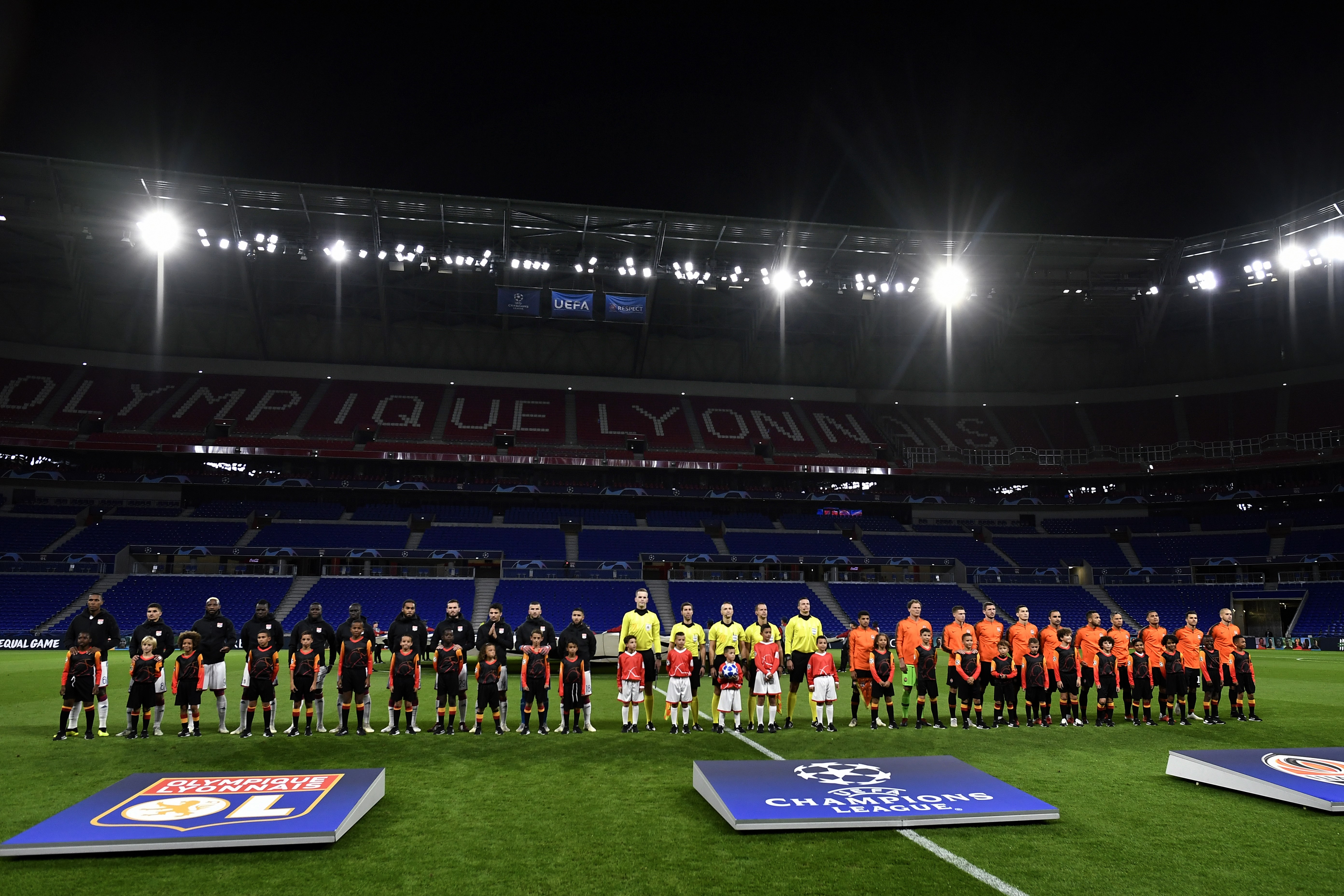 Lyon (L) and Shakthar Donetsk teams pose in an empty stadium before their UEFA Champions League Group F football match Olympique Lyonnais vs FC Shakhtar Donetsk at the OL stadium in Decines-Charpieu on October 2, 2018. - Lyon was ordered by UEFA to play its first Champions League group-stage home game without public as a punishment for racism and crowd disorder in last season's Europa League. (Photo by JEFF PACHOUD / AFP)        (Photo credit should read JEFF PACHOUD/AFP/Getty Images)