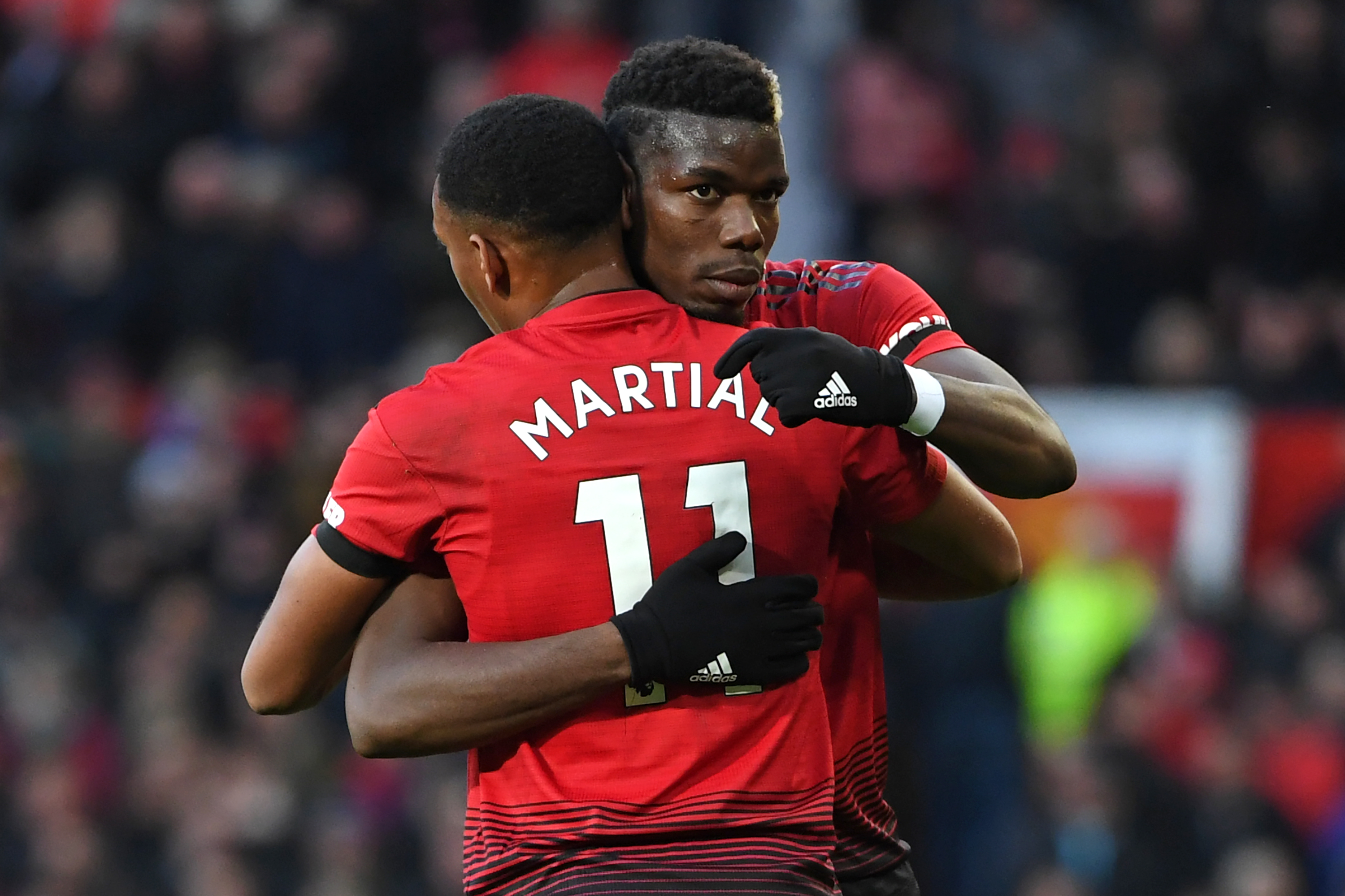 Manchester United's French midfielder Paul Pogba celebrates with Manchester United's French striker Anthony Martial (L) after scoring the opening goal of the English Premier League football match between Manchester United and Everton at Old Trafford in Manchester, north west England, on October 28, 2018. (Photo by Paul ELLIS / AFP) / RESTRICTED TO EDITORIAL USE. No use with unauthorized audio, video, data, fixture lists, club/league logos or 'live' services. Online in-match use limited to 120 images. An additional 40 images may be used in extra time. No video emulation. Social media in-match use limited to 120 images. An additional 40 images may be used in extra time. No use in betting publications, games or single club/league/player publications. /         (Photo credit should read PAUL ELLIS/AFP/Getty Images)