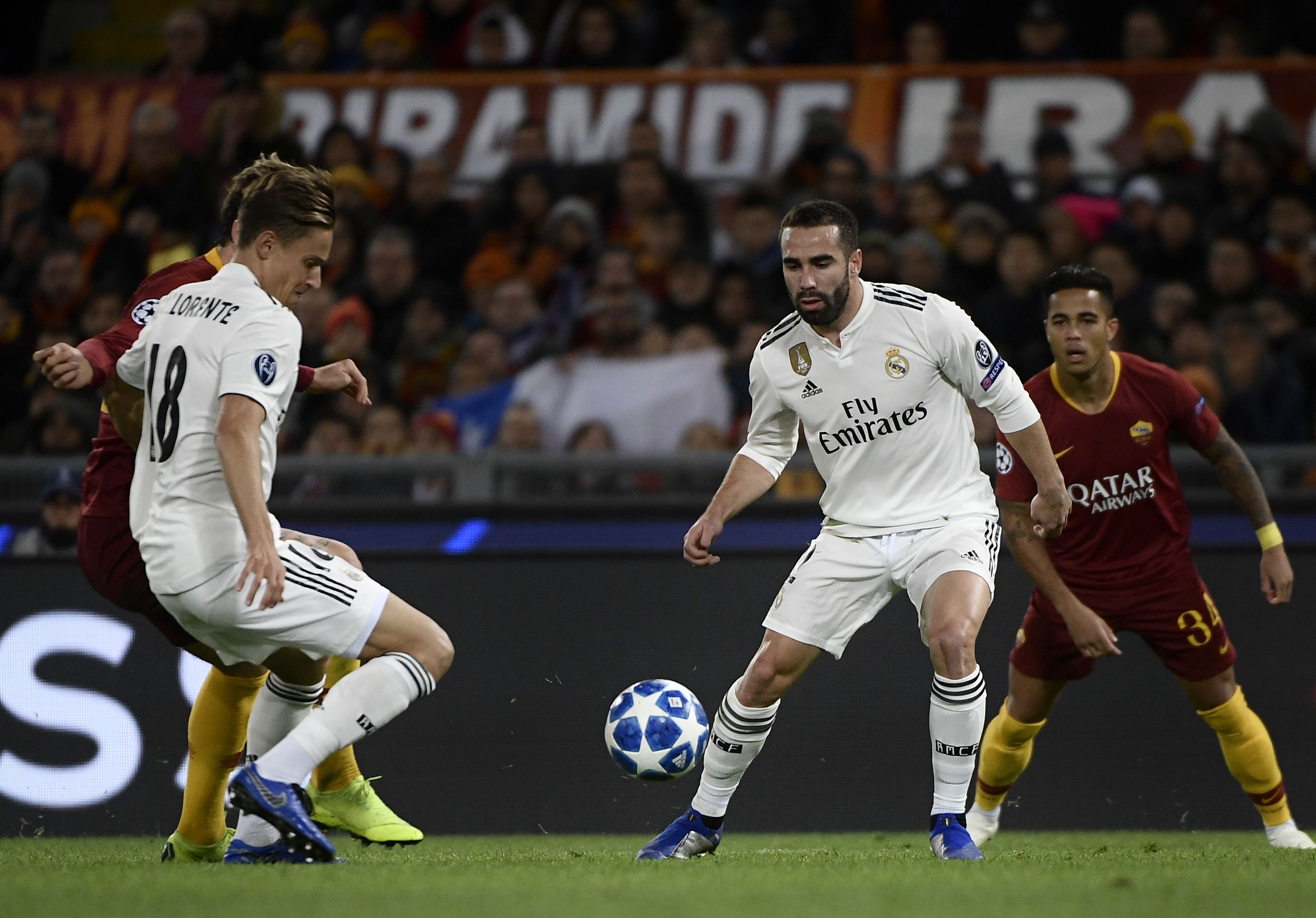 Real Madrid's Spanish miedfieder Marcos Llorente (L) and Real Madrid's Spanish defender Dani Carvajal go for the ball during the UEFA Champions League group G football match AS Rome vs Real Madrid on November 27, 2018 at the Olympic stadium in Rome. (Photo by Filippo MONTEFORTE / AFP)        (Photo credit should read FILIPPO MONTEFORTE/AFP/Getty Images)