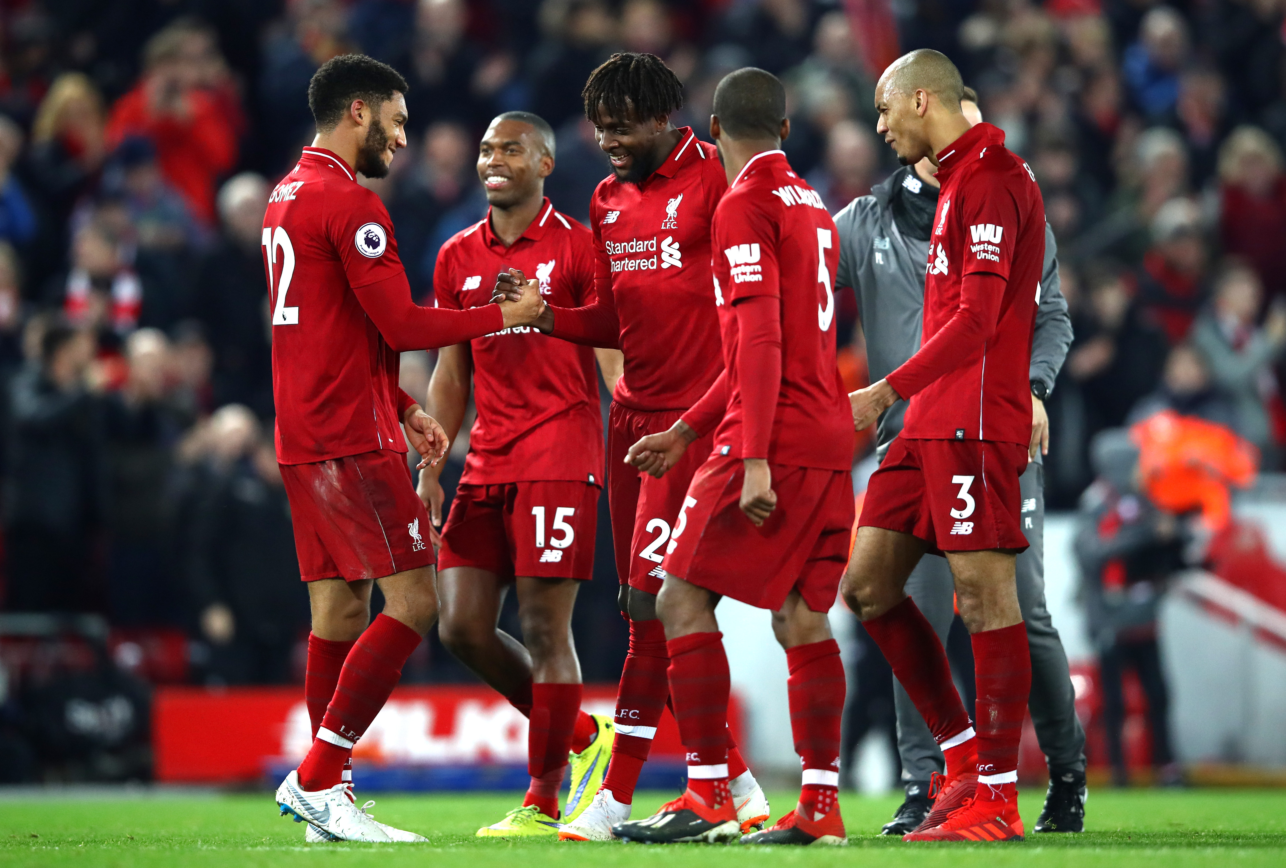 LIVERPOOL, ENGLAND - DECEMBER 02:  Divock Origi of Liverpool celebrates his team's victory with teammate Joe Gomez after the Premier League match between Liverpool FC and Everton FC at Anfield on December 2, 2018 in Liverpool, United Kingdom.  (Photo by Clive Brunskill/Getty Images)