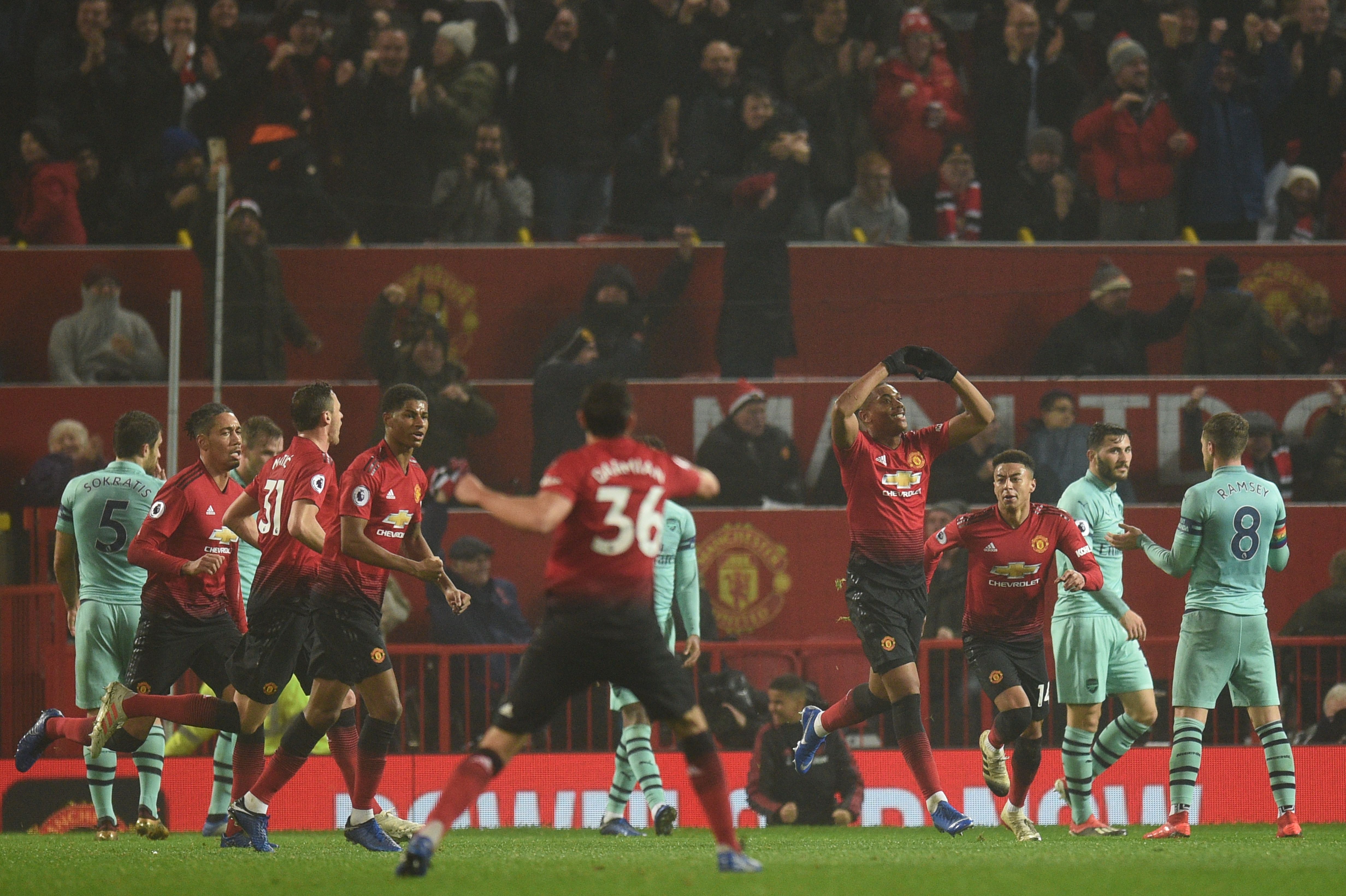 Manchester United's French striker Anthony Martial (4R) celebrates scoring their first goal to equalise 1-1 during the English Premier League football match between Manchester United and Arsenal at Old Trafford in Manchester, north west England, on December 5, 2018. (Photo by Oli SCARFF / AFP) / RESTRICTED TO EDITORIAL USE. No use with unauthorized audio, video, data, fixture lists, club/league logos or 'live' services. Online in-match use limited to 120 images. An additional 40 images may be used in extra time. No video emulation. Social media in-match use limited to 120 images. An additional 40 images may be used in extra time. No use in betting publications, games or single club/league/player publications. /         (Photo credit should read OLI SCARFF/AFP/Getty Images)