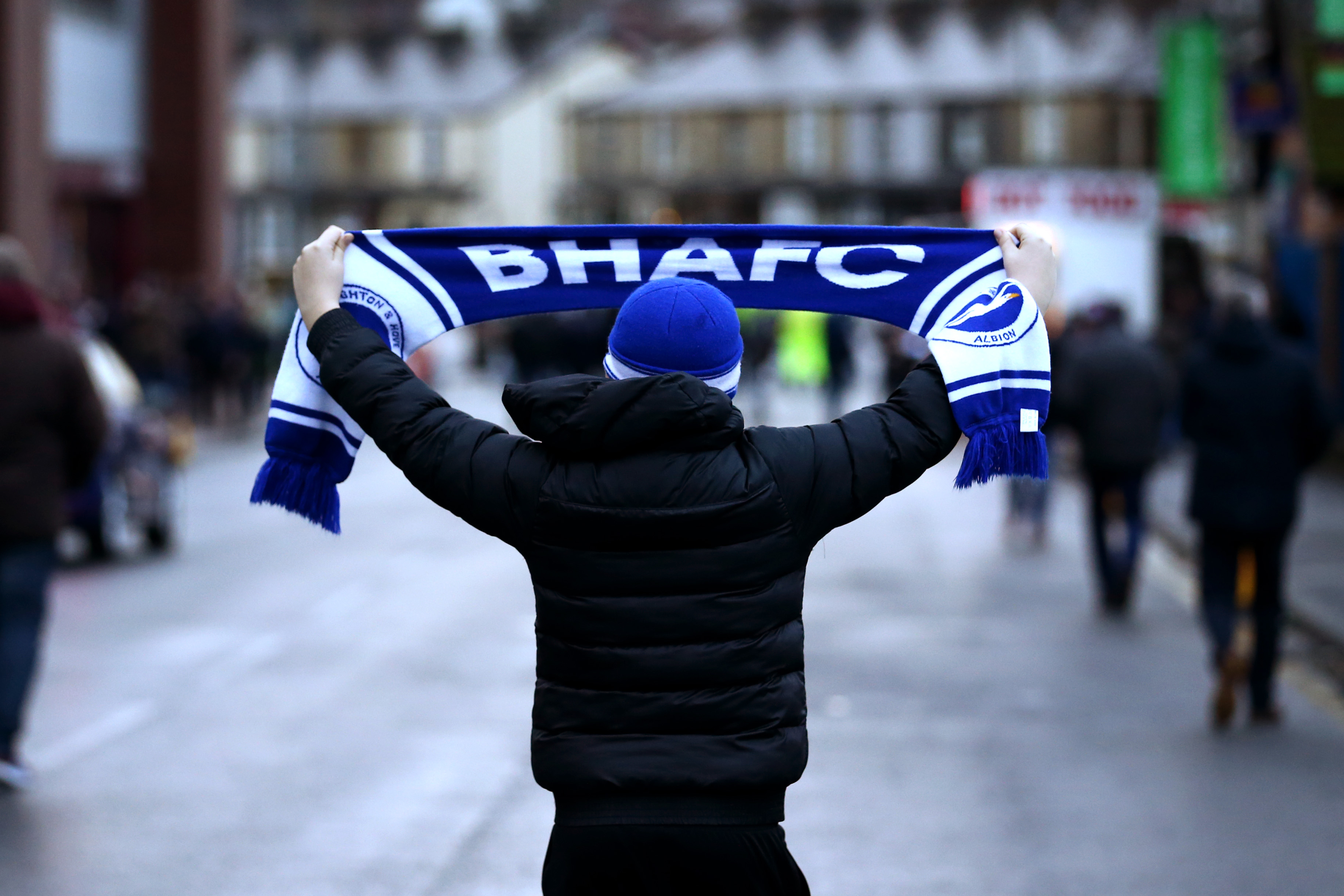 BURNLEY, ENGLAND - DECEMBER 08: A Brighton and Hove Albion fan holds up a scarf prior to the Premier League match between Burnley FC and Brighton & Hove Albion at Turf Moor on December 8, 2018 in Burnley, United Kingdom.  (Photo by Jan Kruger/Getty Images)