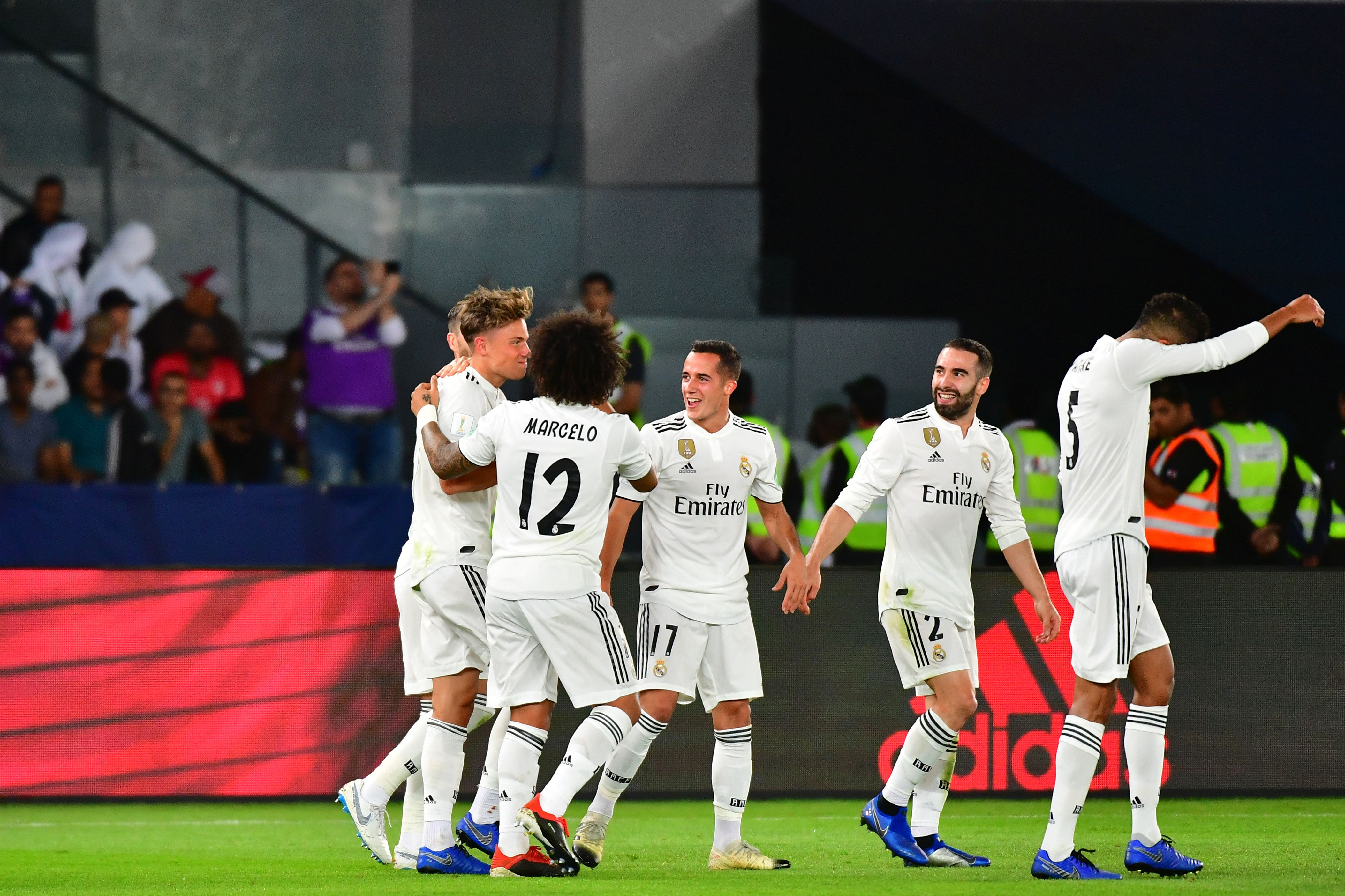 Real Madrid's Spanish midfielder Marcos Llorente (L) celebrates after scoring a goal during the FIFA Club World Cup final football match Spain's Real Madrid vs Abu Dhabi's Al Ain at the Zayed Sports City Stadium in Abu Dhabi, the capital of the United Arab Emirates, on December 22, 2018. (Photo by Giuseppe CACACE / AFP)        (Photo credit should read GIUSEPPE CACACE/AFP/Getty Images)