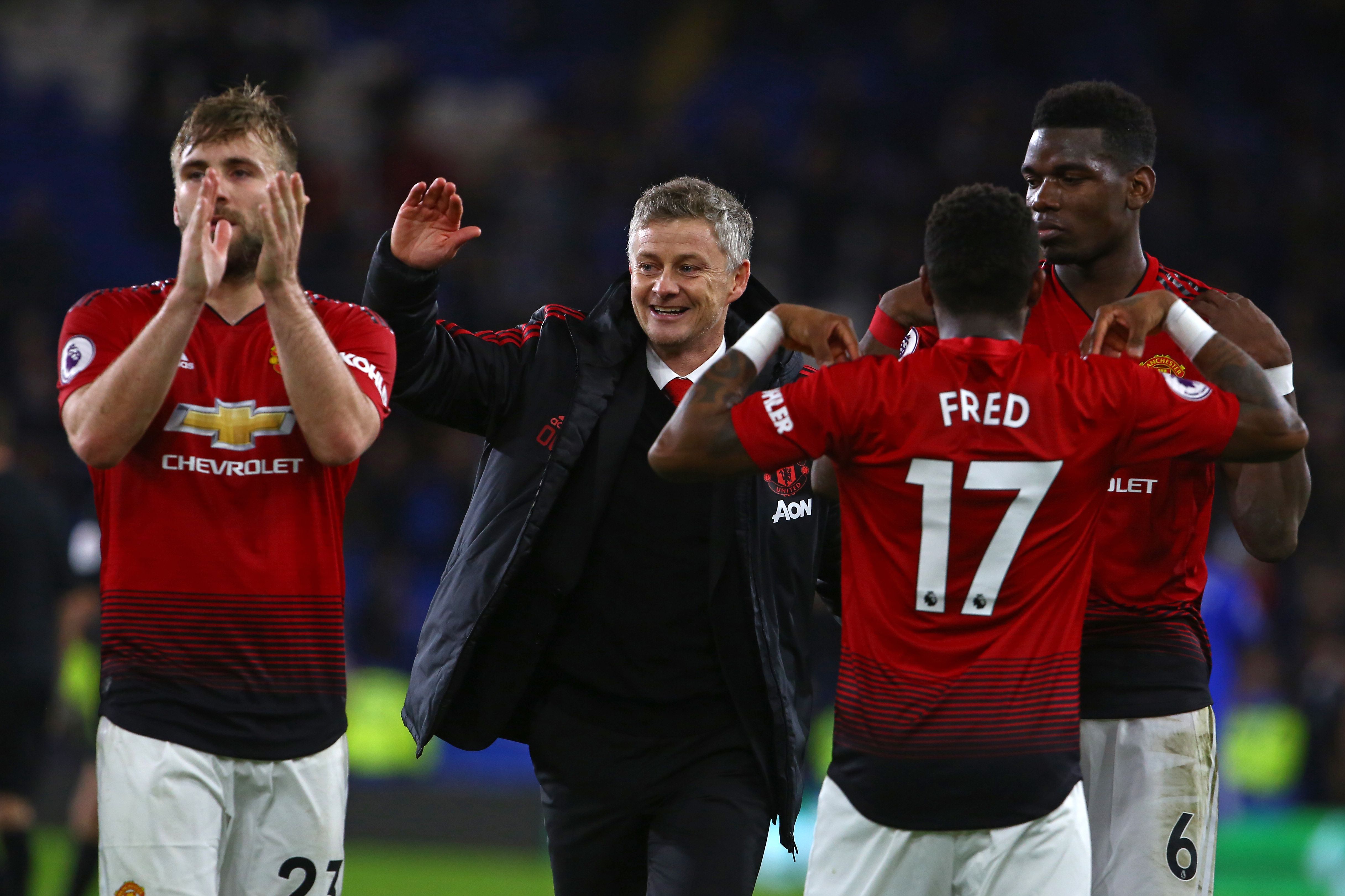TOPSHOT - Manchester United's Norwegian caretaker manager Ole Gunnar Solskjaer (C) celebrates with his players on the pitch after the English Premier League football match between between Cardiff City and Manchester United at Cardiff City Stadium in Cardiff, south Wales on  December 22, 2018. - Manchester United won the game 5-1. (Photo by Geoff CADDICK / AFP) / RESTRICTED TO EDITORIAL USE. No use with unauthorized audio, video, data, fixture lists, club/league logos or 'live' services. Online in-match use limited to 120 images. An additional 40 images may be used in extra time. No video emulation. Social media in-match use limited to 120 images. An additional 40 images may be used in extra time. No use in betting publications, games or single club/league/player publications. /         (Photo credit should read GEOFF CADDICK/AFP/Getty Images)