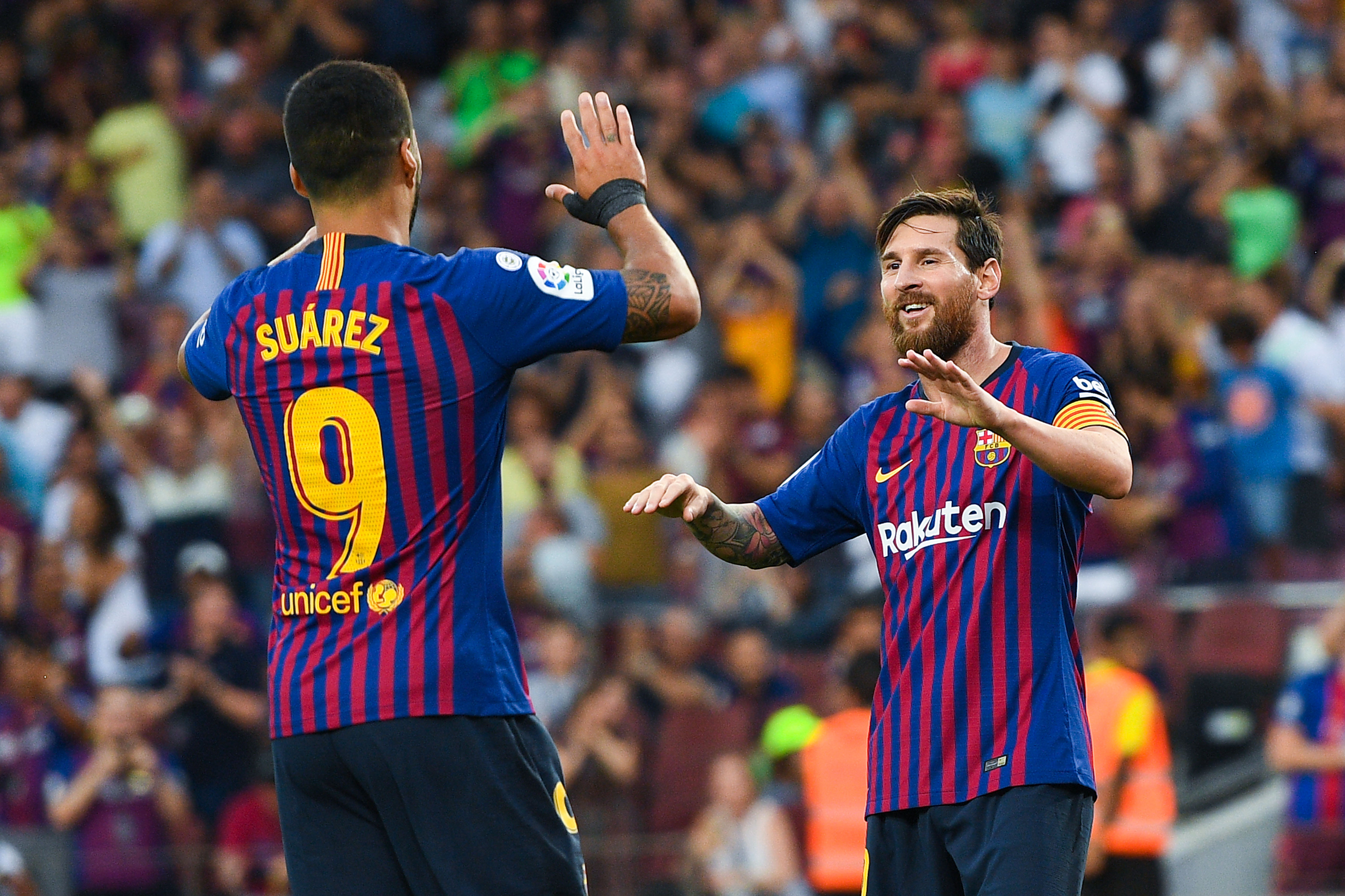 BARCELONA, SPAIN - SEPTEMBER 02:  Lionel Messi of FC Barcelona celebrates with his team ate Luis Suarez after scoring his team's sixth goal during the La Liga match between FC Barcelona and SD Huesca at Camp Nou on September 2, 2018 in Barcelona, Spain.  (Photo by David Ramos/Getty Images)