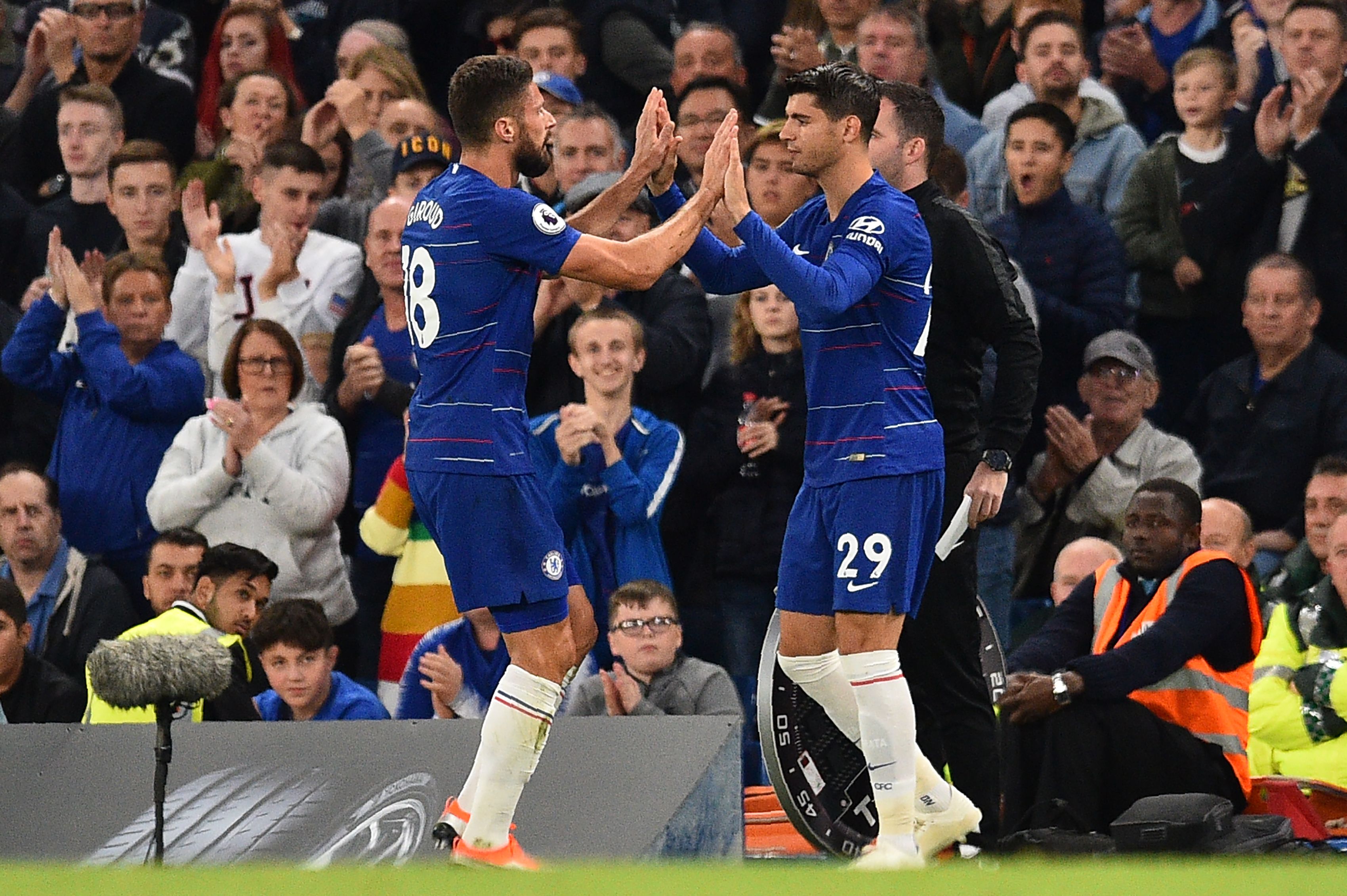 Chelsea's French striker Olivier Giroud (L) is substituted by Chelsea's Spanish striker Alvaro Morata during the English Premier League football match between Chelsea and Liverpool at Stamford Bridge in London on September 29, 2018. (Photo by Glyn KIRK / AFP) / RESTRICTED TO EDITORIAL USE. No use with unauthorized audio, video, data, fixture lists, club/league logos or 'live' services. Online in-match use limited to 120 images. An additional 40 images may be used in extra time. No video emulation. Social media in-match use limited to 120 images. An additional 40 images may be used in extra time. No use in betting publications, games or single club/league/player publications. /         (Photo credit should read GLYN KIRK/AFP/Getty Images)