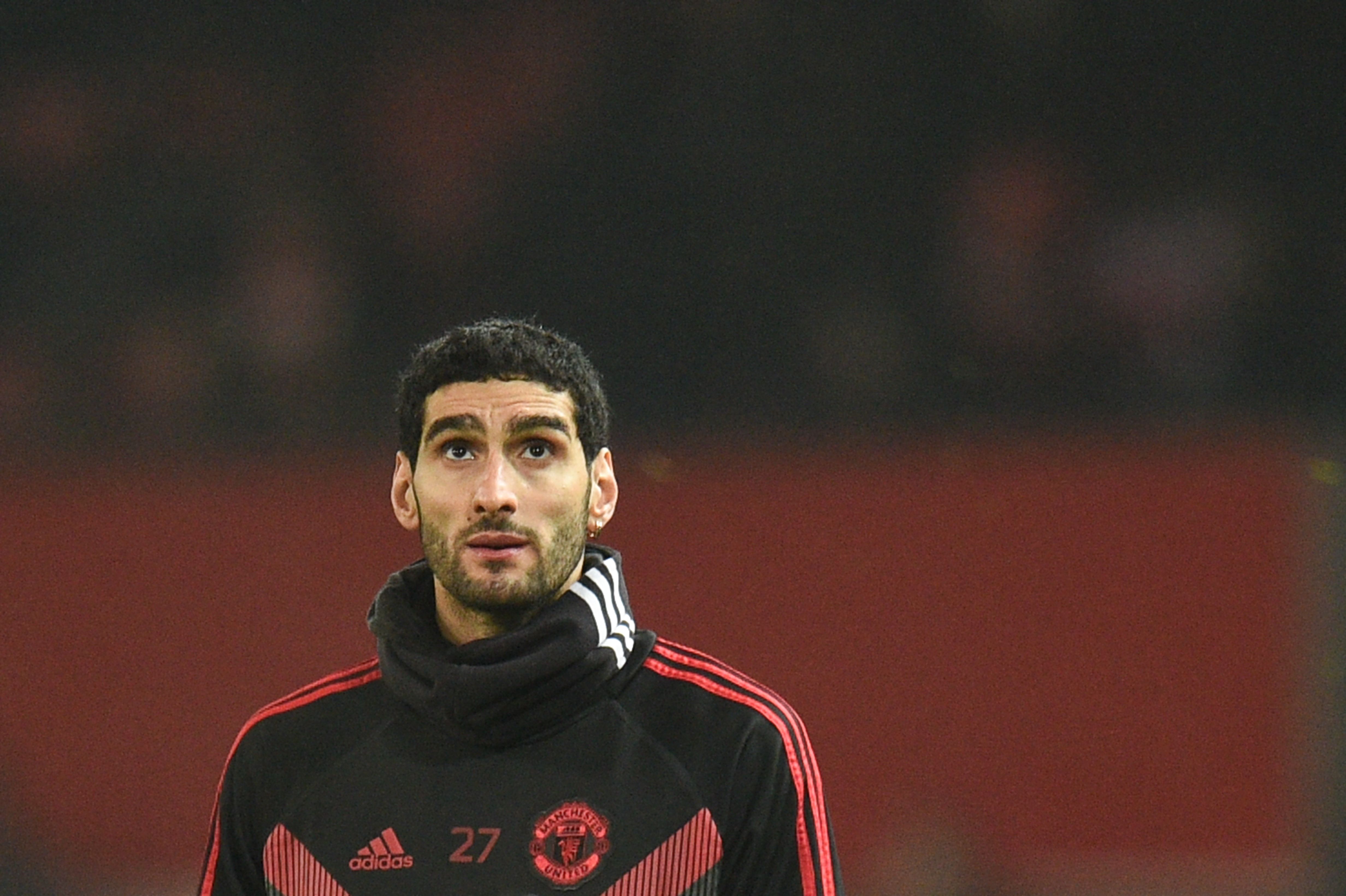 Manchester United's Belgian midfielder Marouane Fellaini warms up for the English Premier League football match between Manchester United and Arsenal at Old Trafford in Manchester, north west England, on December 5, 2018. (Photo by Oli SCARFF / AFP) / RESTRICTED TO EDITORIAL USE. No use with unauthorized audio, video, data, fixture lists, club/league logos or 'live' services. Online in-match use limited to 120 images. An additional 40 images may be used in extra time. No video emulation. Social media in-match use limited to 120 images. An additional 40 images may be used in extra time. No use in betting publications, games or single club/league/player publications. /         (Photo credit should read OLI SCARFF/AFP/Getty Images)