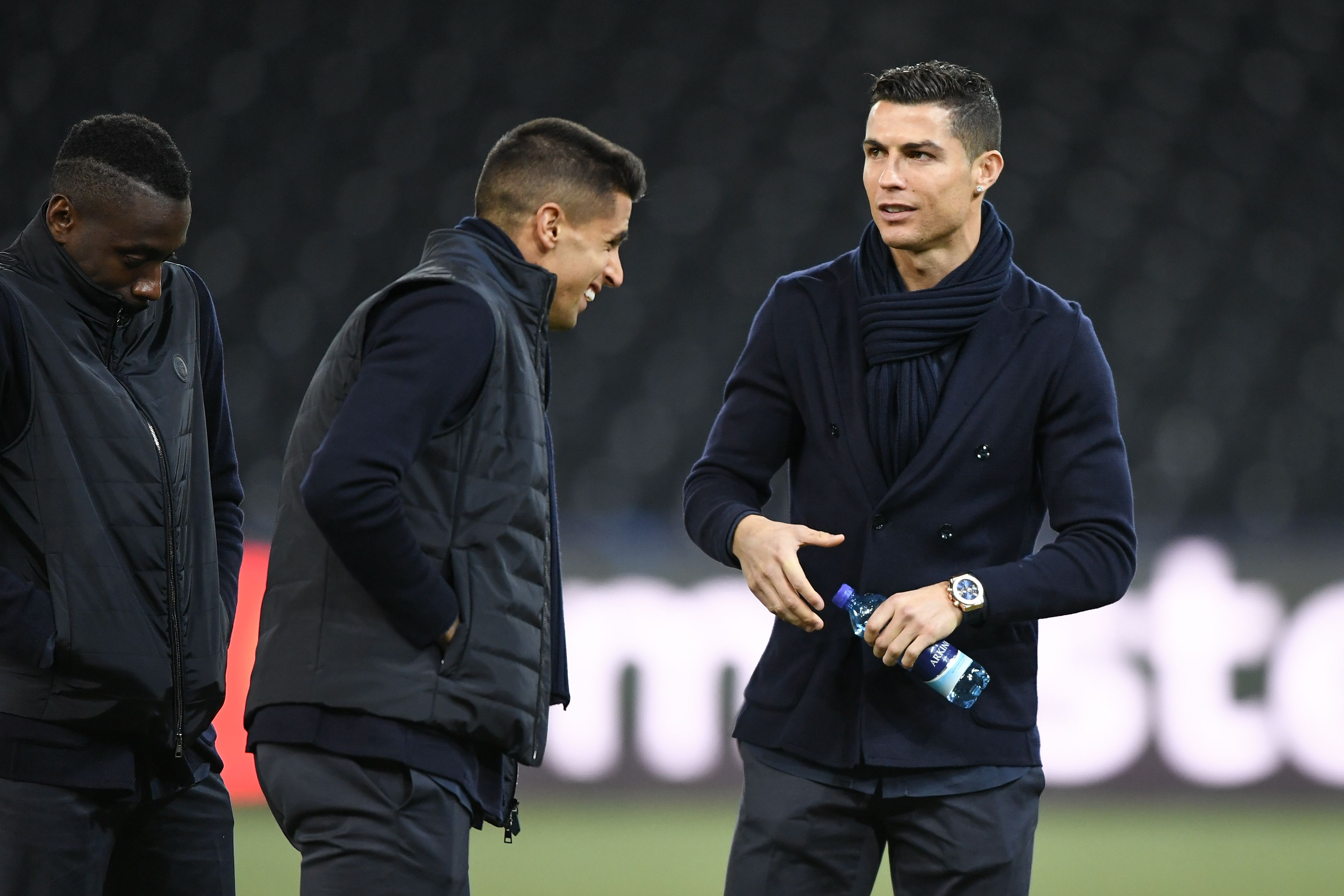 (From L) Juventus' French midfielder Blaise Matuidi, teammate Portuguese defender Joao Cancelo and teammate Portuguese forward Cristiano Ronaldo inspect the pitch ahead of the Champions League Group H football match between Young Boys and Juventus at the Stade de Suisse stadium on December 11, 2018 in Bern. (Photo by FABRICE COFFRINI / AFP)        (Photo credit should read FABRICE COFFRINI/AFP/Getty Images)