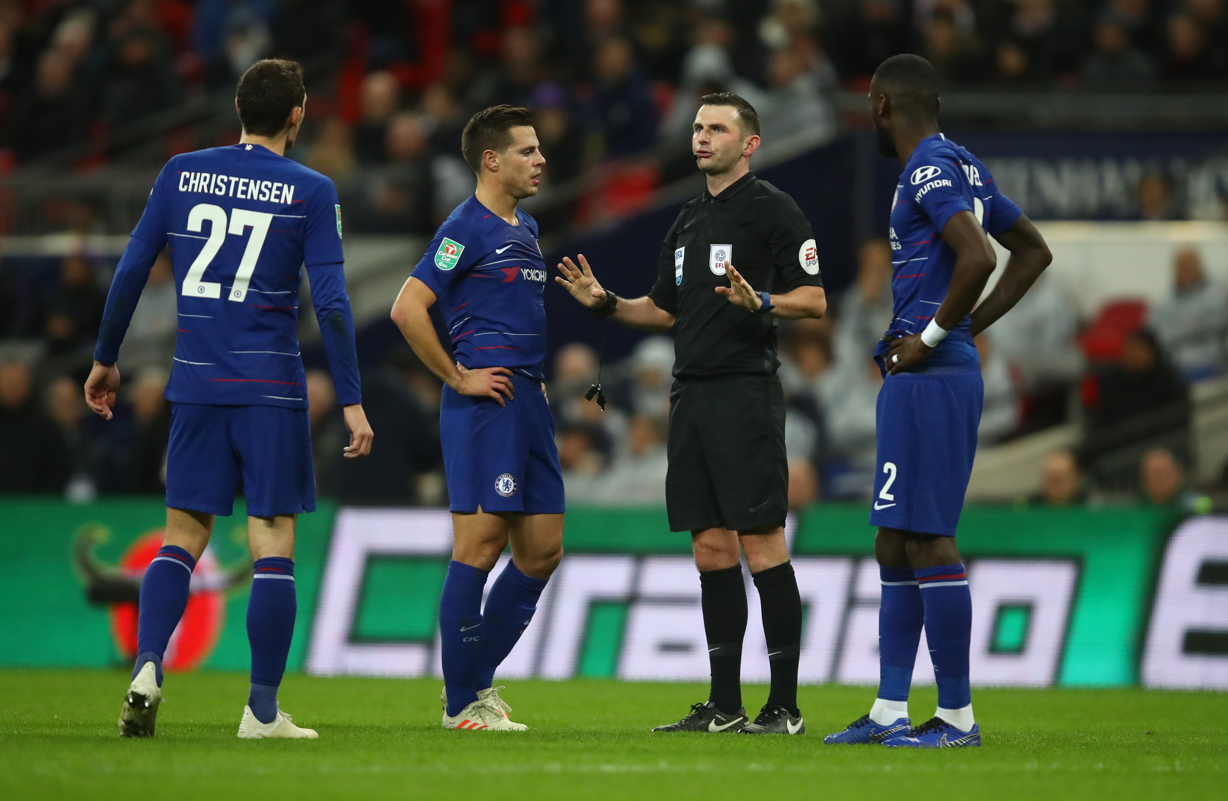 LONDON, ENGLAND - JANUARY 08: Referee Michael Oliver speaks to Cesar Azpilicueta of Chelsea as he waits for the VAR during the Carabao Cup Semi-Final First Leg match between Tottenham Hotspur and Chelsea at Wembley Stadium on January 8, 2019 in London, England.  (Photo by Julian Finney/Getty Images)