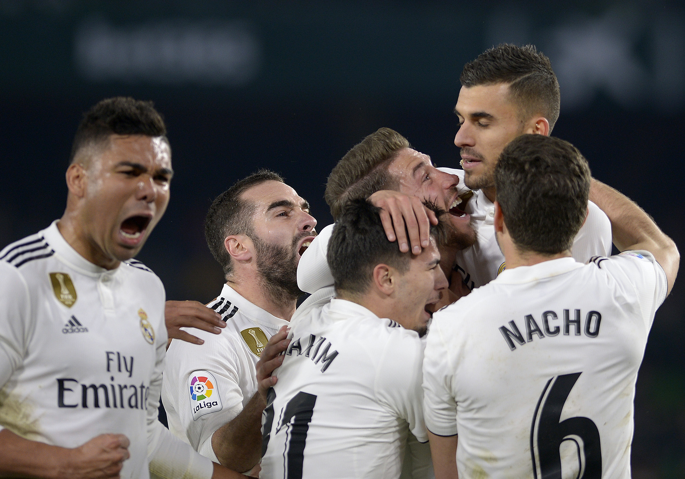 Real Madrid's Spanish midfielder Daniel Ceballos (2R) celebrates with teammates after scoring a goal during the Spanish League football match between Real Betis and Real Madrid CF at the Benito Villamarin stadium in Seville on January 13, 2019. (Photo by CRISTINA QUICLER / AFP)        (Photo credit should read CRISTINA QUICLER/AFP/Getty Images)