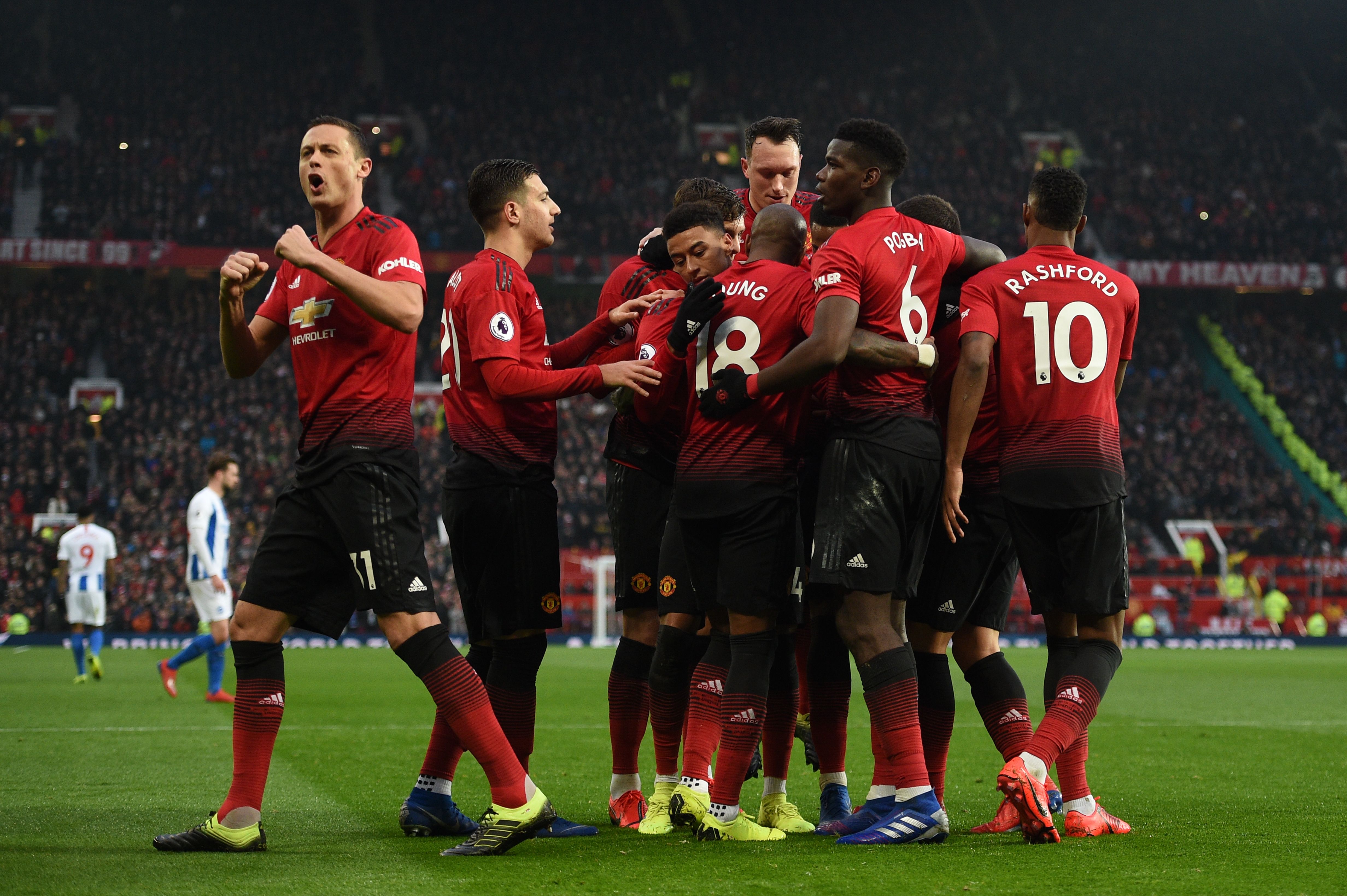 Manchester United's French midfielder Paul Pogba (2R) celebrates scoring the opening goal from the penalty spot with team-mates during the English Premier League football match between Manchester United and Brighton and Hove Albion at Old Trafford in Manchester, north west England, on January 19, 2019. (Photo by Oli SCARFF / AFP) / RESTRICTED TO EDITORIAL USE. No use with unauthorized audio, video, data, fixture lists, club/league logos or 'live' services. Online in-match use limited to 120 images. An additional 40 images may be used in extra time. No video emulation. Social media in-match use limited to 120 images. An additional 40 images may be used in extra time. No use in betting publications, games or single club/league/player publications. /         (Photo credit should read OLI SCARFF/AFP/Getty Images)
