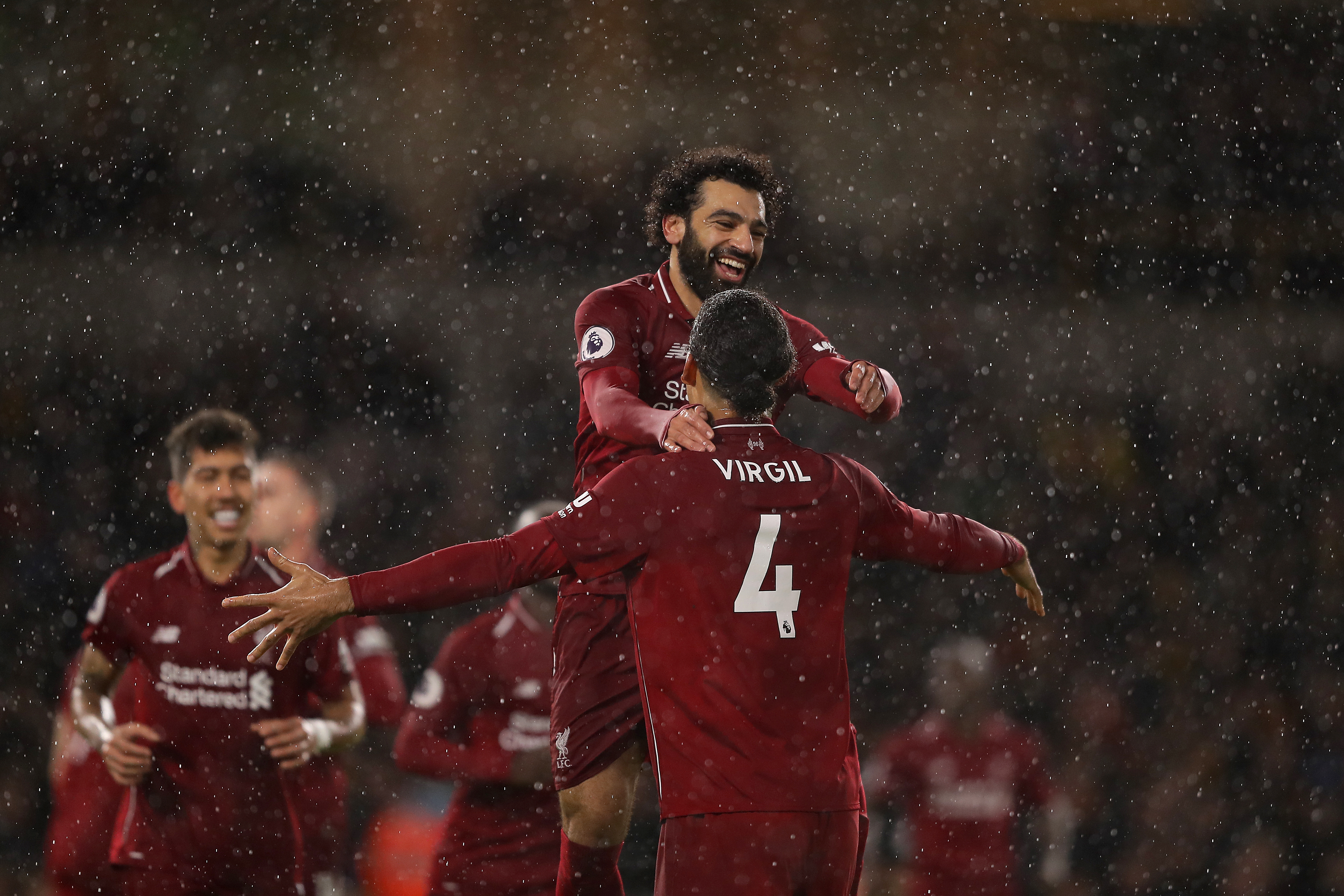 WOLVERHAMPTON, ENGLAND - DECEMBER 21: Mohamed Salah of Liverpool is congratulated by Virgil Van Dijk as he celebrates scoring the first goal during the Premier League match between Wolverhampton Wanderers and Liverpool FC at Molineux on December 21, 2018 in Wolverhampton, United Kingdom. (Photo by Richard Heathcote/Getty Images)
