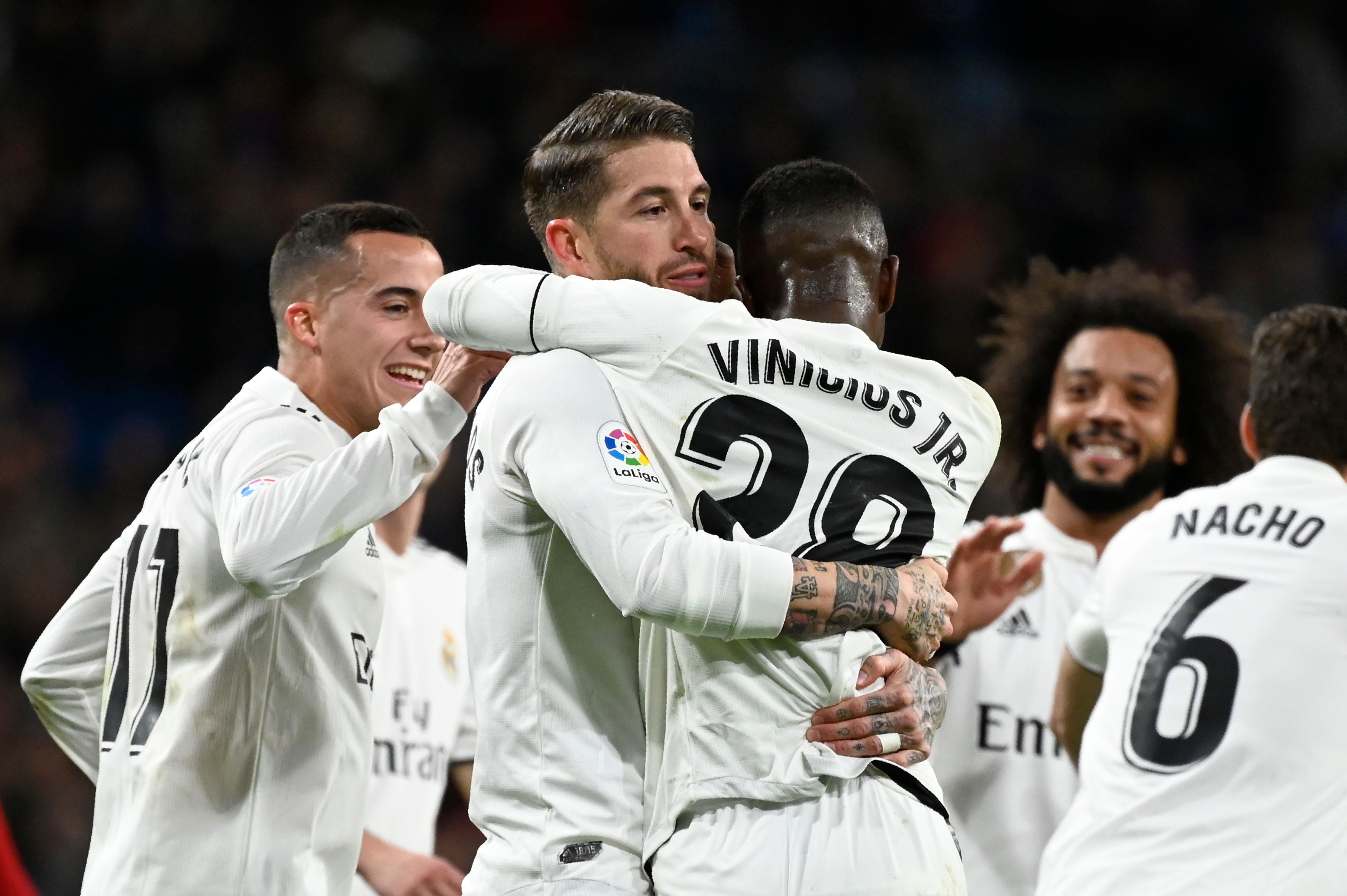 Real Madrid's Spanish defender Sergio Ramos (C) celebrates with teammates after scoring a penalty during the Spanish Copa del Rey (King's Cup) quarter-final first leg football match between Real Madrid CF and Girona FC at the Santiago Bernabeu stadium in Madrid on January 24, 2019. (Photo by JAVIER SORIANO / AFP)        (Photo credit should read JAVIER SORIANO/AFP/Getty Images)