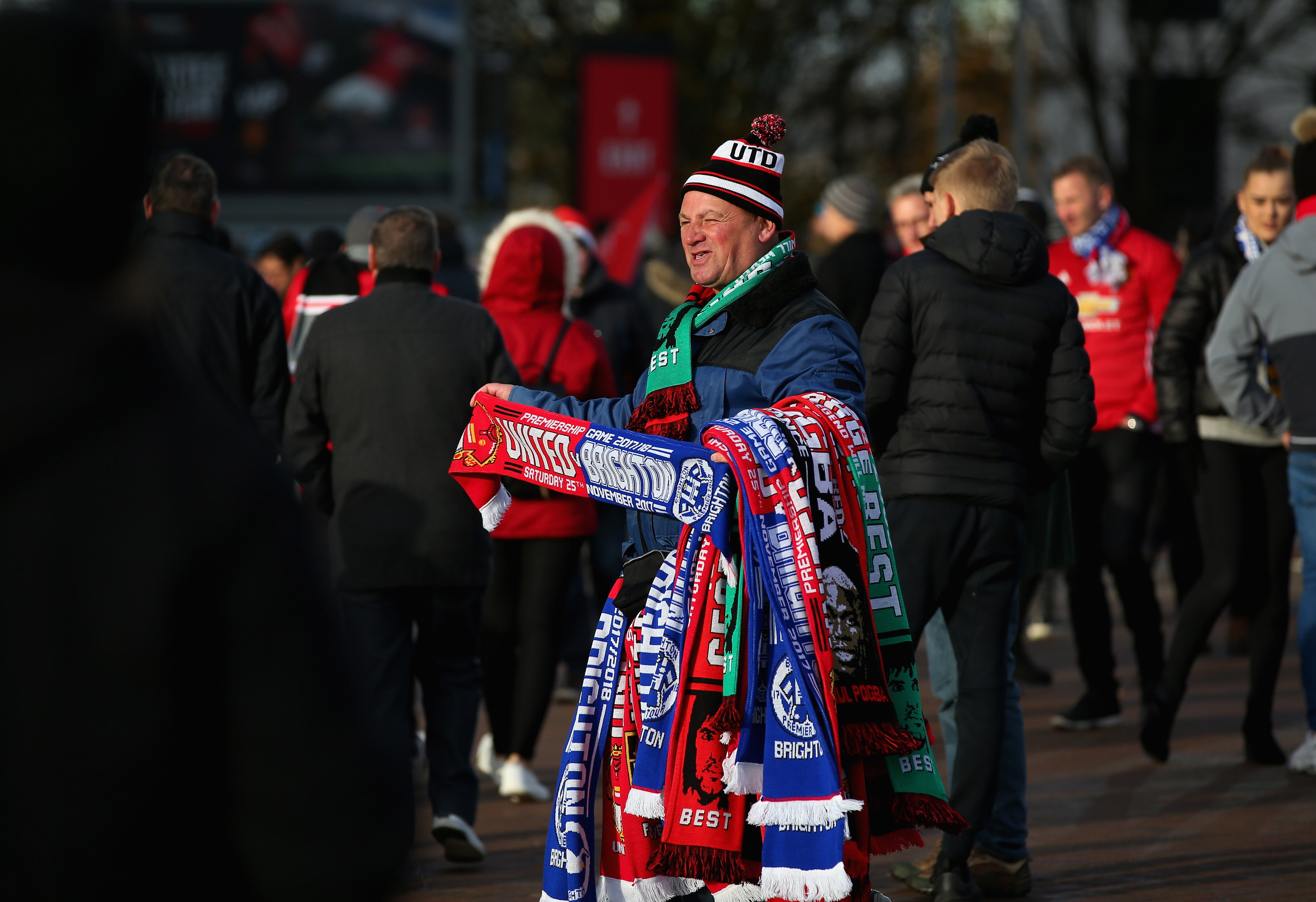 MANCHESTER, ENGLAND - NOVEMBER 25:  A scarf seller is seen outside Old Trafford prior to the Premier League match between Manchester United and Brighton and Hove Albion at Old Trafford on November 25, 2017 in Manchester, England.  (Photo by Alex Livesey/Getty Images)
