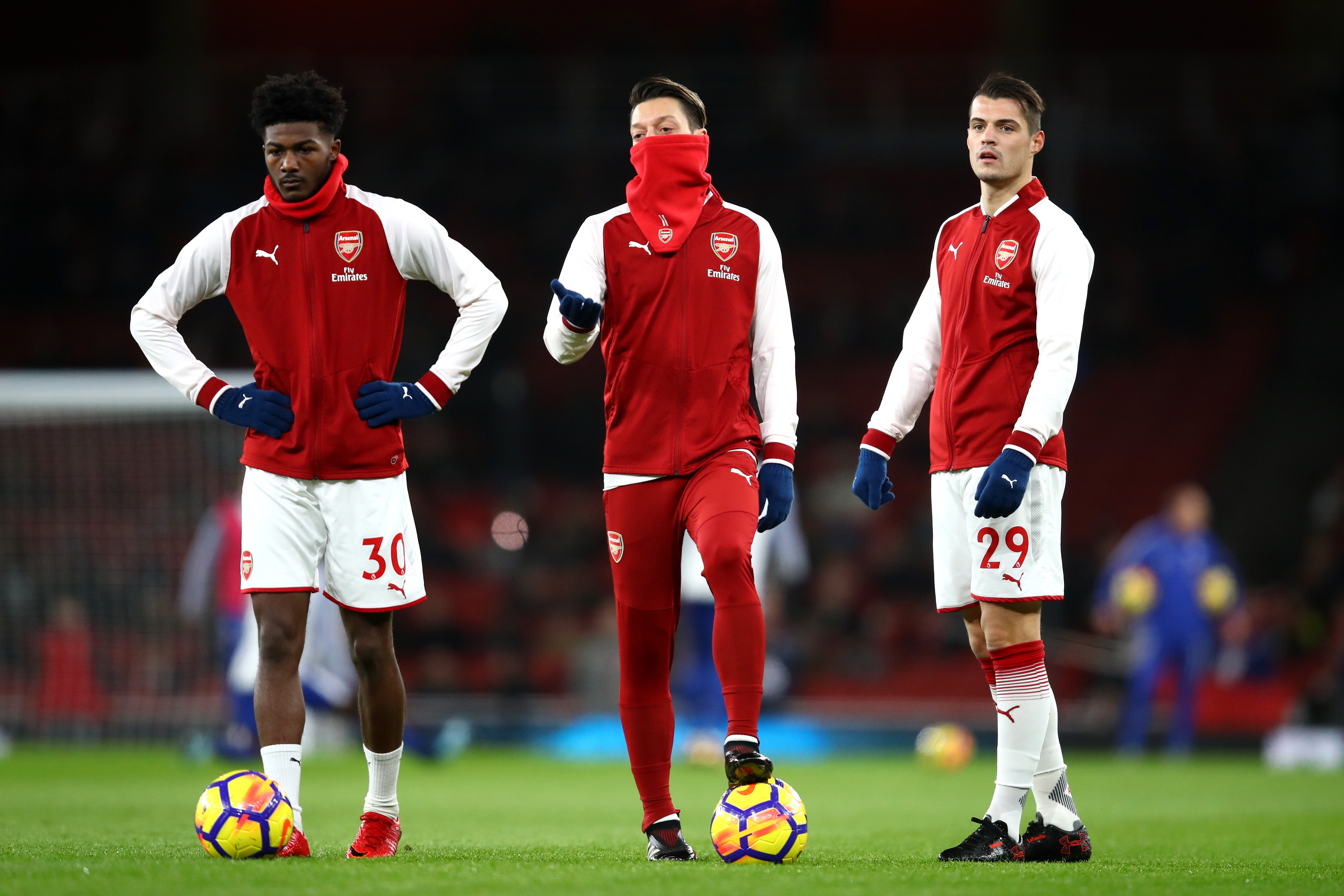 LONDON, ENGLAND - JANUARY 03:  Ainsley Maitland-Niles, Mesut Ozil and Granit Xhaka of Arsenal warm up prior to the Premier League match between Arsenal and Chelsea at Emirates Stadium on January 3, 2018 in London, England.  (Photo by Julian Finney/Getty Images)