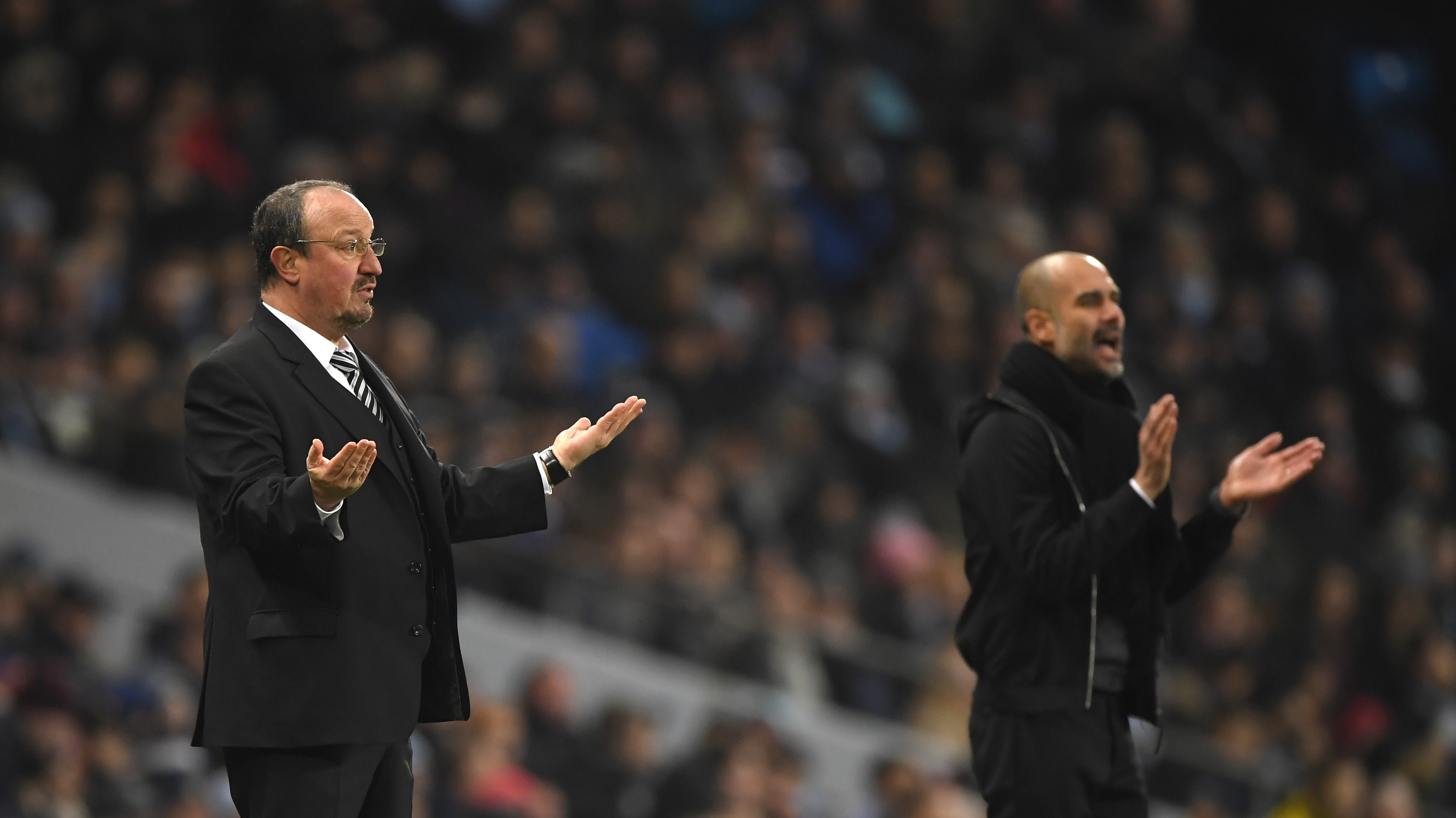 MANCHESTER, ENGLAND - JANUARY 20: Rafael Benitez, Manager of Newcastle United and Josep Guardiola, Manager of Manchester City react during the Premier League match between Manchester City and Newcastle United at Etihad Stadium on January 20, 2018 in Manchester, England.  (Photo by Stu Forster/Getty Images)