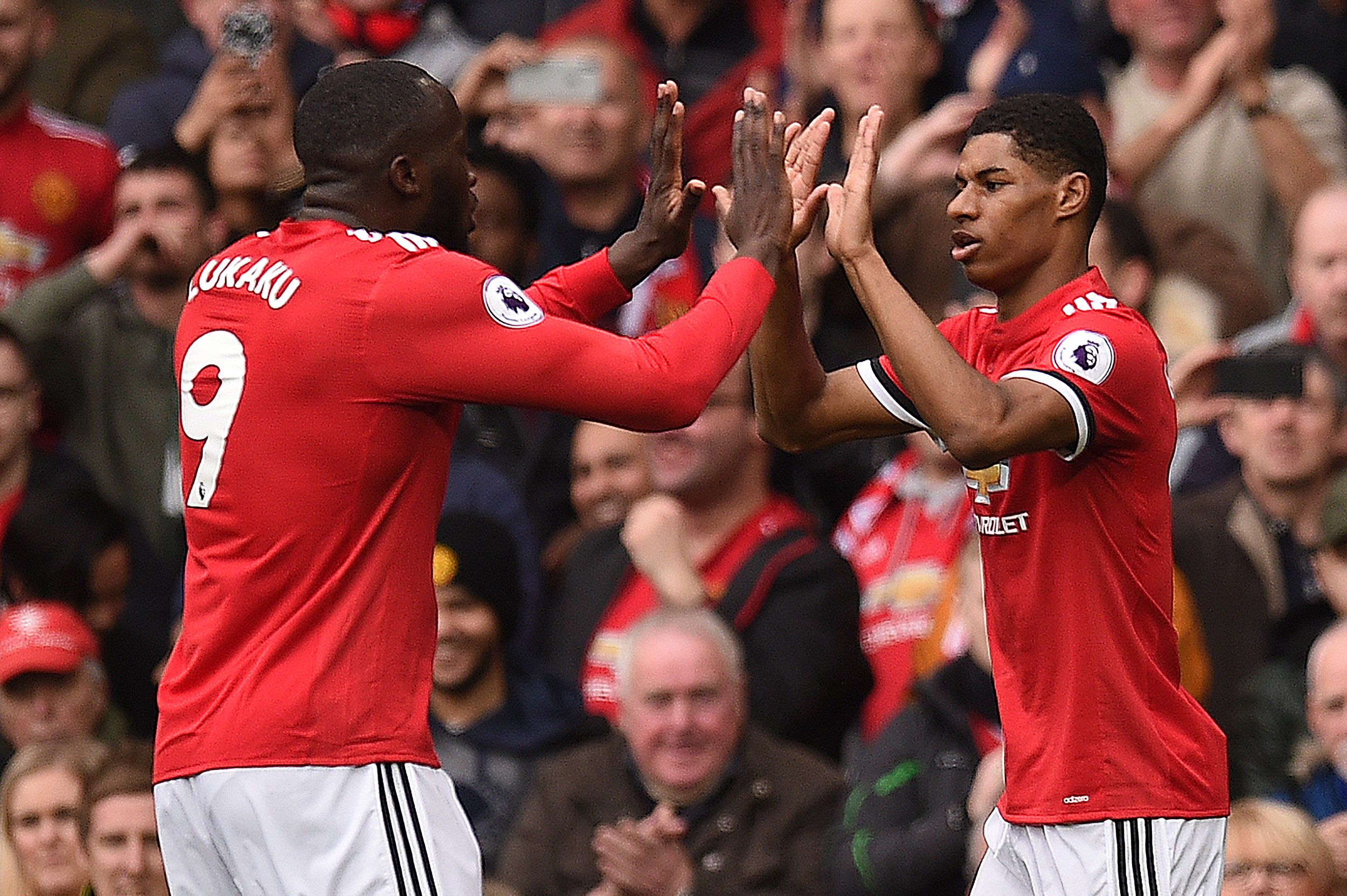 Manchester United's English striker Marcus Rashford (R) celebrates scoring the opening goal with Manchester United's Belgian striker Romelu Lukaku (L) during the English Premier League football match between Manchester United and Liverpool at Old Trafford in Manchester, north west England, on March 10, 2018. / AFP PHOTO / Oli SCARFF / RESTRICTED TO EDITORIAL USE. No use with unauthorized audio, video, data, fixture lists, club/league logos or 'live' services. Online in-match use limited to 75 images, no video emulation. No use in betting, games or single club/league/player publications.  /         (Photo credit should read OLI SCARFF/AFP/Getty Images)