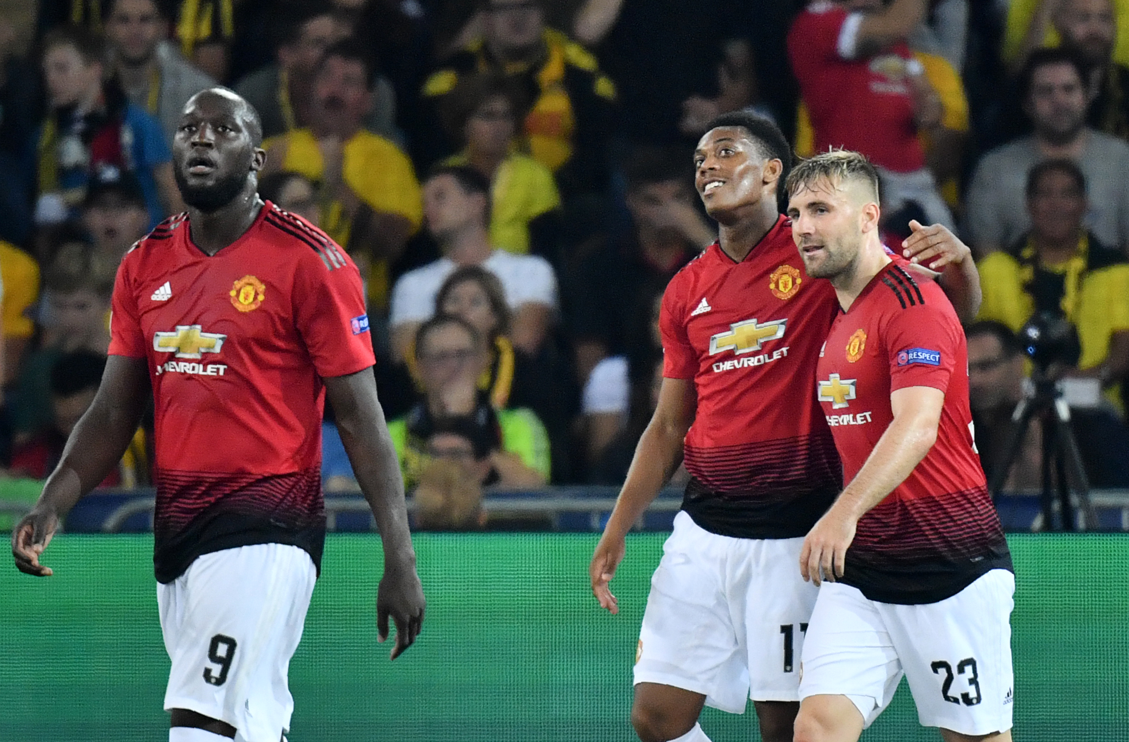 Manchester United's French striker Anthony Martial (C) celebrates after scoring with teammates Romelu Lukaku (L) and Luke Shaw (R) during the UEFA Champions League group H football match between Young Boys and Manchester United at The Stade de Suisse in Bern on September 19, 2018. (Photo by Alain GROSCLAUDE / AFP)        (Photo credit should read ALAIN GROSCLAUDE/AFP/Getty Images)