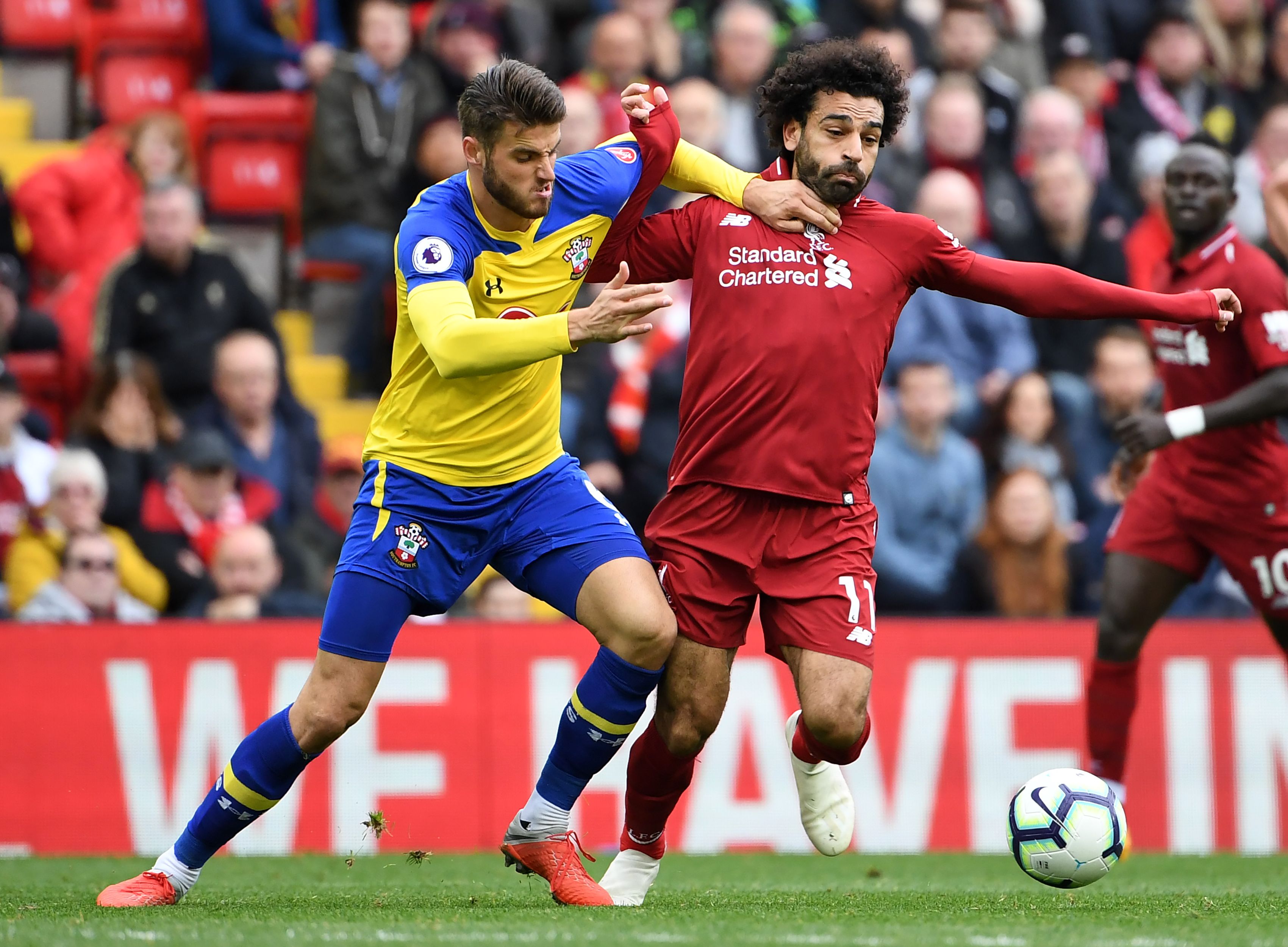 Southampton's English striker Danny Ings (L) vies with Liverpool's Egyptian midfielder Mohamed Salah during the English Premier League football match between Liverpool and Southampton at Anfield in Liverpool, north west England on September 22, 2018. (Photo by Paul ELLIS / AFP) / RESTRICTED TO EDITORIAL USE. No use with unauthorized audio, video, data, fixture lists, club/league logos or 'live' services. Online in-match use limited to 120 images. An additional 40 images may be used in extra time. No video emulation. Social media in-match use limited to 120 images. An additional 40 images may be used in extra time. No use in betting publications, games or single club/league/player publications. /         (Photo credit should read PAUL ELLIS/AFP/Getty Images)