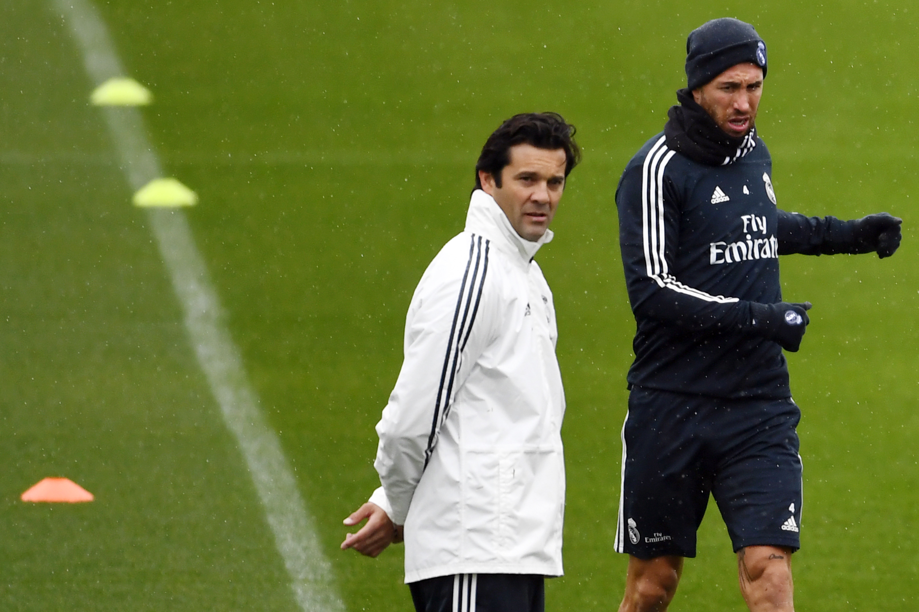 Temporary coach of Real Madrid CF, Argentinian former player Santiago Solari (L) and Real Madrid's Spanish defender Sergio Ramos attend a training session at the Ciudad Real Madrid training facilities in Madrid's suburb of Valdebebas, on October 30, 2018. - Santiago Solari has been put in temporary charge of Real Madrid after Julen Lopetegui was sacked on October 29, 2018. Solari was the coach of Madrid's B team, Castilla, and is now expected to take Madrid for their Copa del Rey game against Melilla tomorrow. (Photo by GABRIEL BOUYS / AFP)        (Photo credit should read GABRIEL BOUYS/AFP/Getty Images)