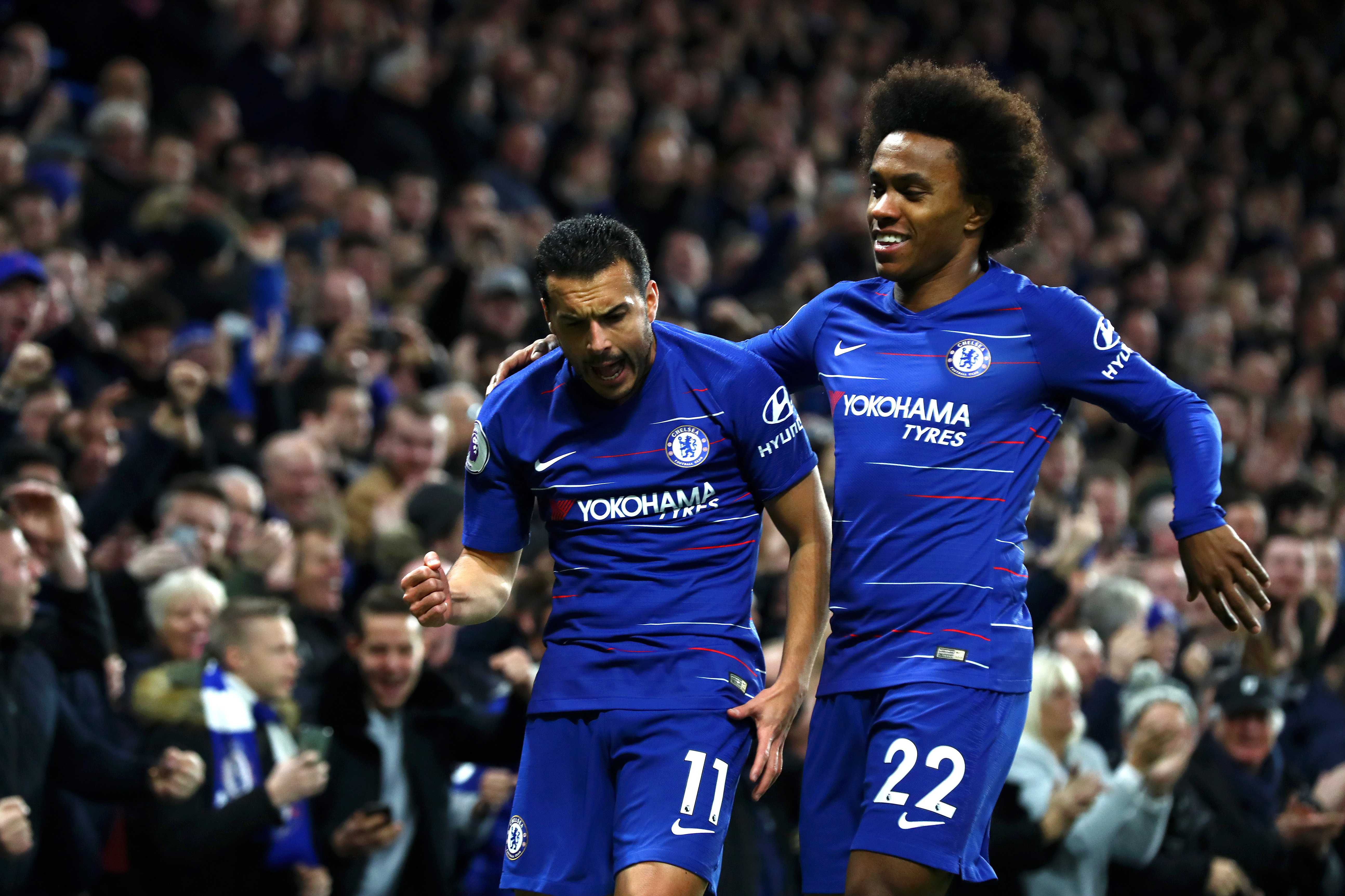 LONDON, ENGLAND - JANUARY 12:  Pedro of Chelsea celebrates with teammate Willian after scoring his team's first goal  during the Premier League match between Chelsea FC and Newcastle United at Stamford Bridge on January 12, 2019 in London, United Kingdom.  (Photo by Clive Rose/Getty Images)
