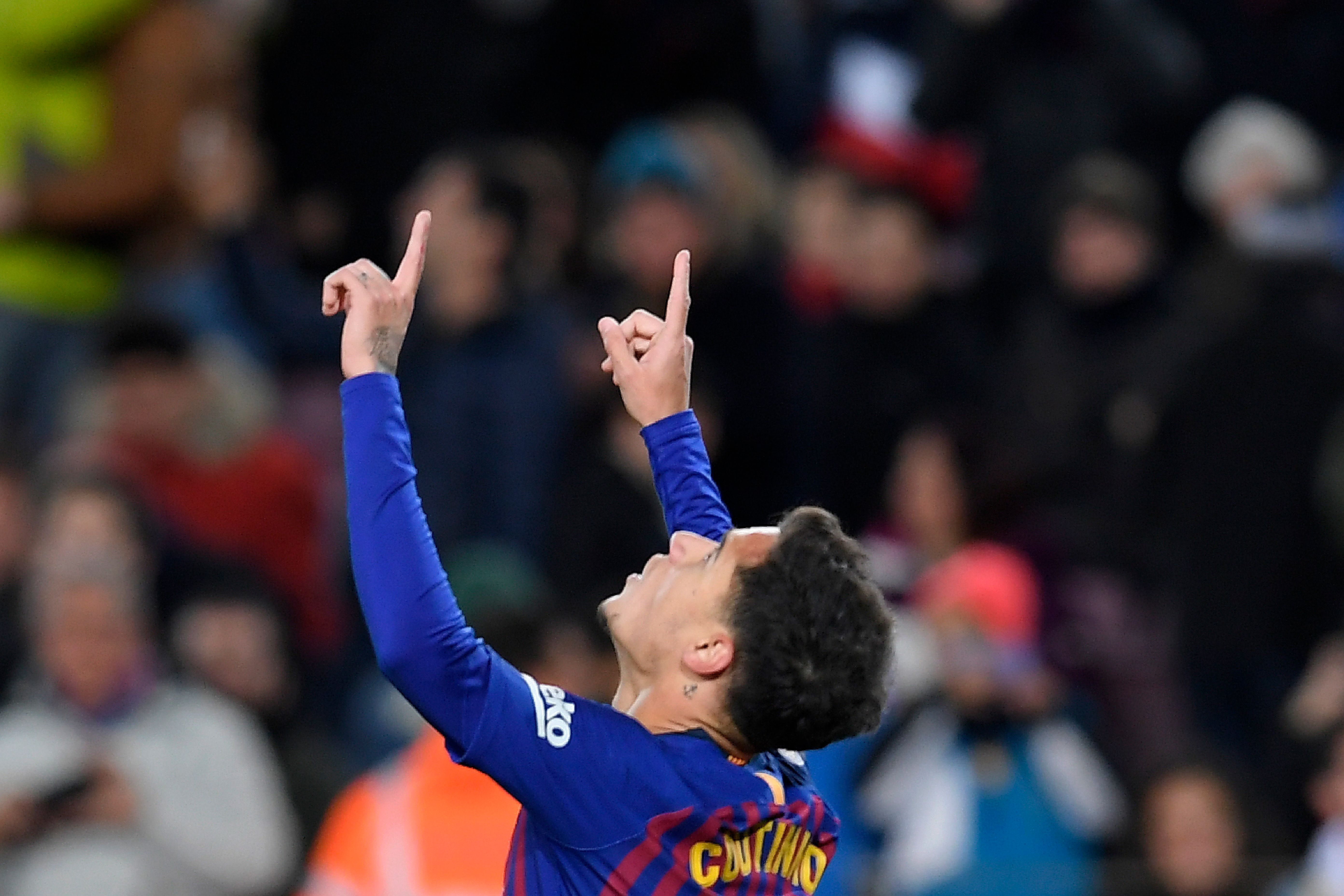 Barcelona's Brazilian midfielder Philippe Coutinho celebrates after scoring a goal during the Spanish Copa del Rey (King's Cup) quarter-final second leg football match between Barcelona and Sevilla at the Camp Nou stadium in Barcelona on January 30, 2019. (Photo by LLUIS GENE / AFP)        (Photo credit should read LLUIS GENE/AFP/Getty Images)
