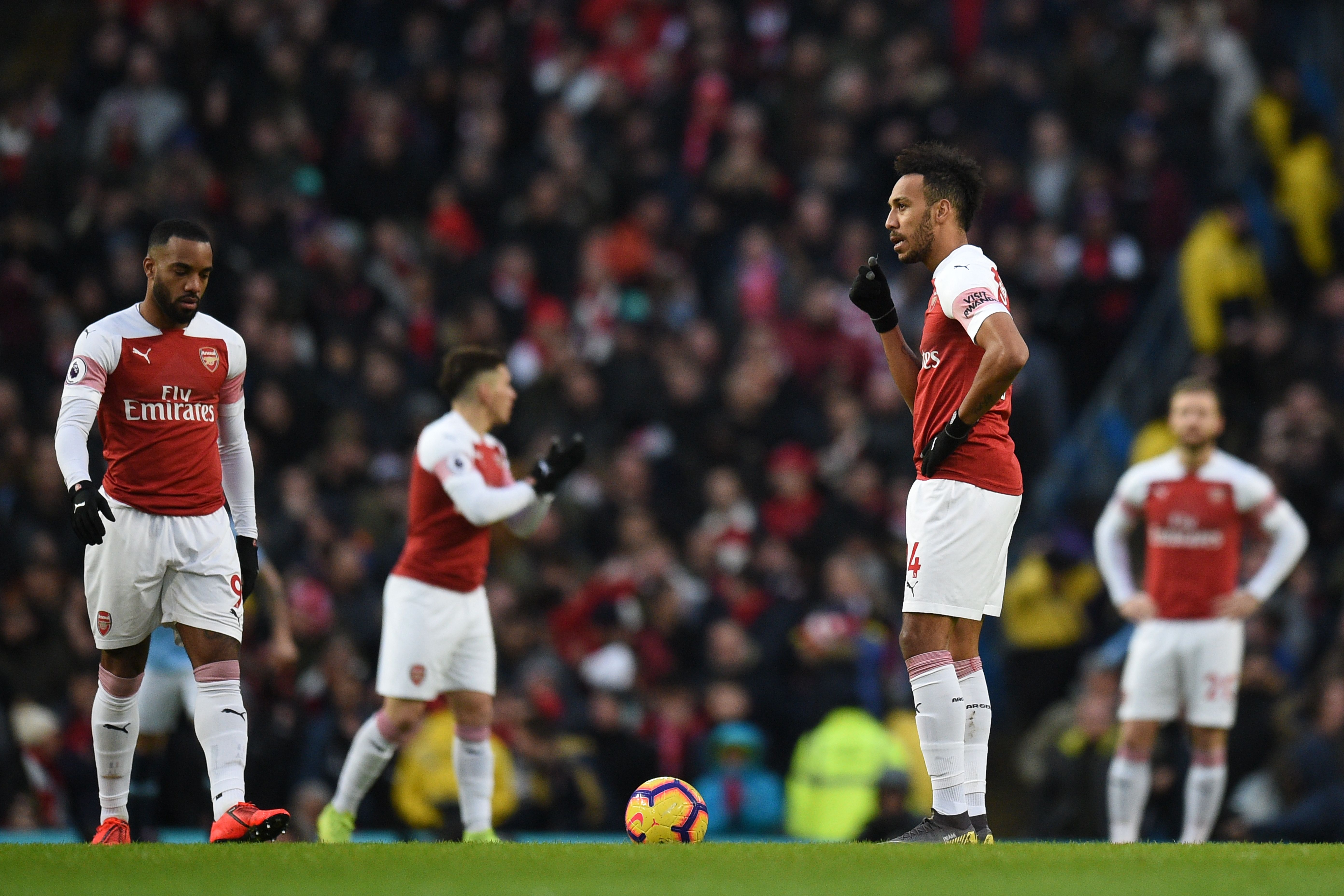 Arsenal's Gabonese striker Pierre-Emerick Aubameyang (2nd R) prepares to take the kick off after they concede an early goal during the English Premier League football match between Manchester City and Arsenal at the Etihad Stadium in Manchester, north west England, on February 3, 2019. (Photo by Oli SCARFF / AFP) / RESTRICTED TO EDITORIAL USE. No use with unauthorized audio, video, data, fixture lists, club/league logos or 'live' services. Online in-match use limited to 120 images. An additional 40 images may be used in extra time. No video emulation. Social media in-match use limited to 120 images. An additional 40 images may be used in extra time. No use in betting publications, games or single club/league/player publications. /         (Photo credit should read OLI SCARFF/AFP/Getty Images)