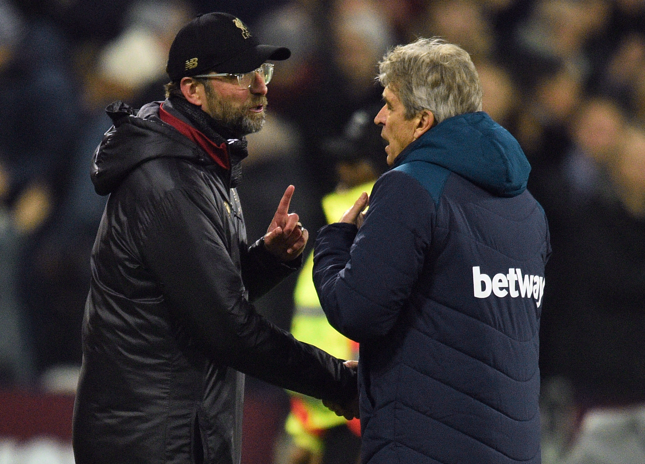 Liverpool's German manager Jurgen Klopp (L) speaks to West Ham United's Chilean manager Manuel Pellegrini after the English Premier League football match between West Ham United and Liverpool at The London Stadium, in east London on February 4, 2019. - The game finished 1-1. (Photo by Glyn KIRK / AFP) / RESTRICTED TO EDITORIAL USE. No use with unauthorized audio, video, data, fixture lists, club/league logos or 'live' services. Online in-match use limited to 120 images. An additional 40 images may be used in extra time. No video emulation. Social media in-match use limited to 120 images. An additional 40 images may be used in extra time. No use in betting publications, games or single club/league/player publications. /         (Photo credit should read GLYN KIRK/AFP/Getty Images)
