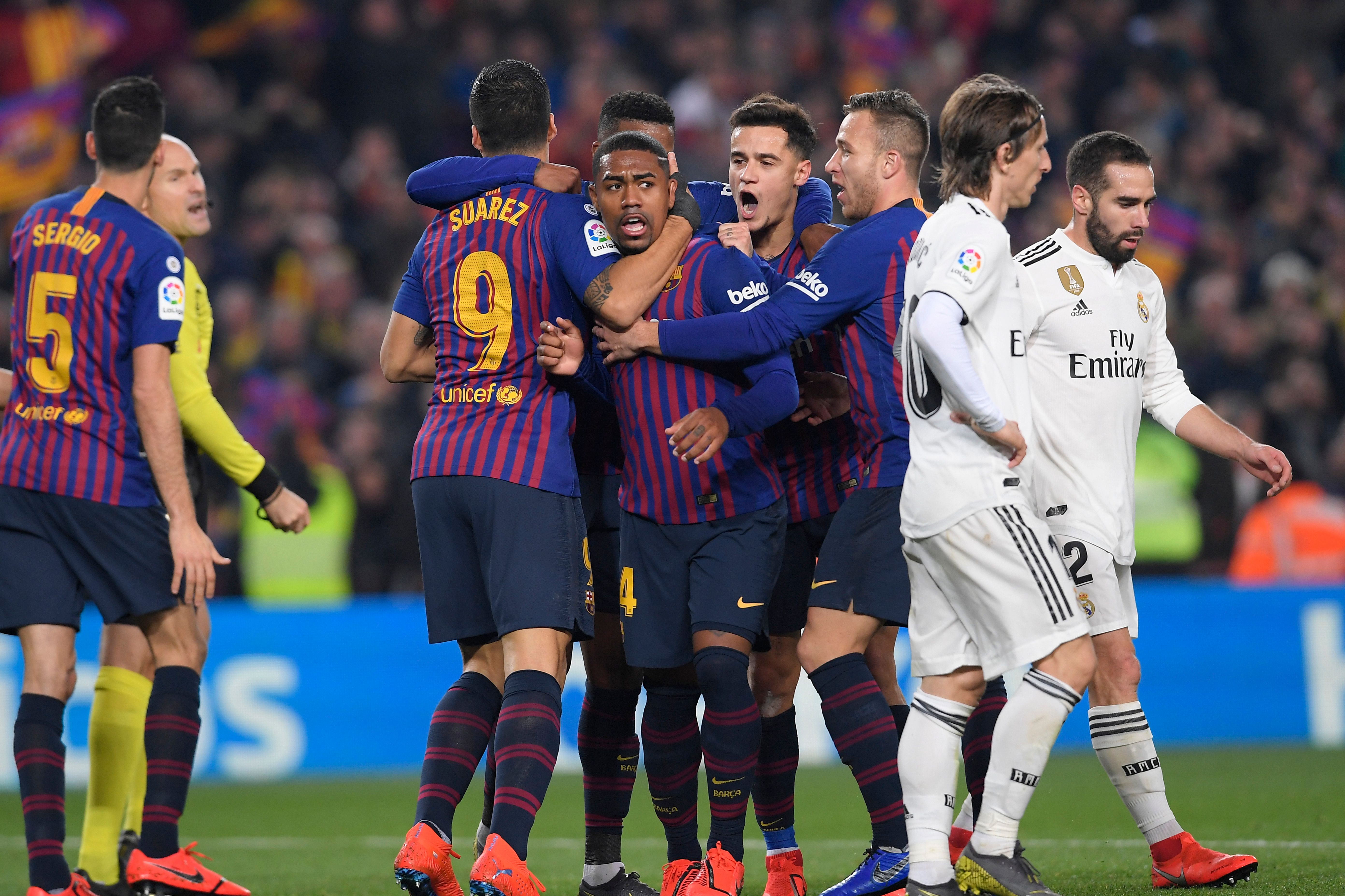 Barcelona's Brazilian midfielder Malcom (C) celebrates after scoring during the Spanish Copa del Rey (King's Cup) semi-final first leg football match between FC Barcelona and Real Madrid CF at the Camp Nou stadium in Barcelona on February 6, 2019. (Photo by LLUIS GENE / AFP)        (Photo credit should read LLUIS GENE/AFP/Getty Images)