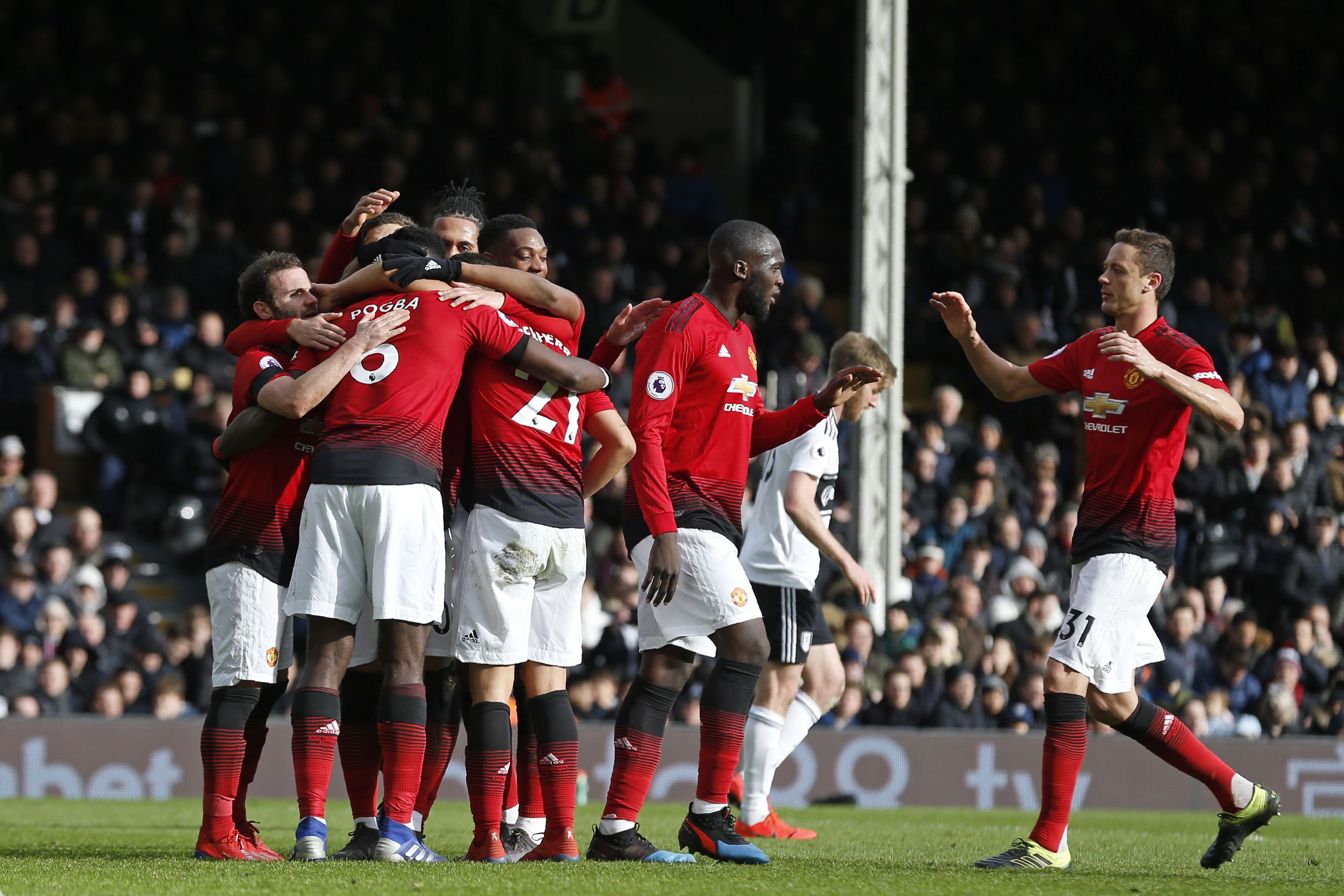 Manchester United's French midfielder Paul Pogba (2nd L) celebrates with teammates after scoring their third goal from the penalty spot during the English Premier League football match between Fulham and Manchester United at Craven Cottage in London on February 9, 2019. (Photo by Ian KINGTON / AFP) / RESTRICTED TO EDITORIAL USE. No use with unauthorized audio, video, data, fixture lists, club/league logos or 'live' services. Online in-match use limited to 120 images. An additional 40 images may be used in extra time. No video emulation. Social media in-match use limited to 120 images. An additional 40 images may be used in extra time. No use in betting publications, games or single club/league/player publications. /         (Photo credit should read IAN KINGTON/AFP/Getty Images)