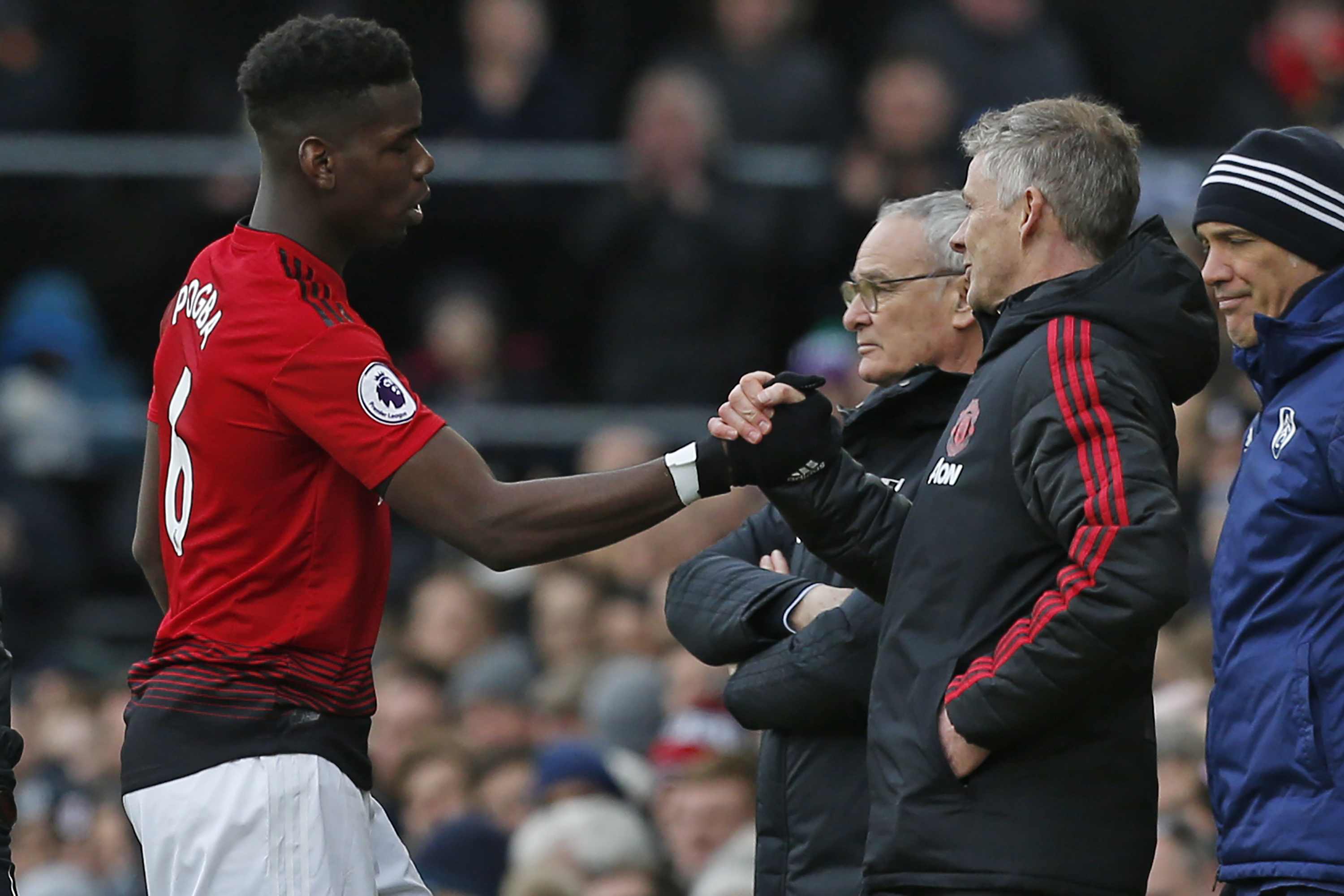 Manchester United's French midfielder Paul Pogba (L) shakes hands with Manchester United's  Norwegian caretaker manager Ole Gunnar Solskjaer after being substituted during the English Premier League football match between Fulham and Manchester United at Craven Cottage in London on February 9, 2019. (Photo by Ian KINGTON / AFP) / RESTRICTED TO EDITORIAL USE. No use with unauthorized audio, video, data, fixture lists, club/league logos or 'live' services. Online in-match use limited to 120 images. An additional 40 images may be used in extra time. No video emulation. Social media in-match use limited to 120 images. An additional 40 images may be used in extra time. No use in betting publications, games or single club/league/player publications. /         (Photo credit should read IAN KINGTON/AFP/Getty Images)