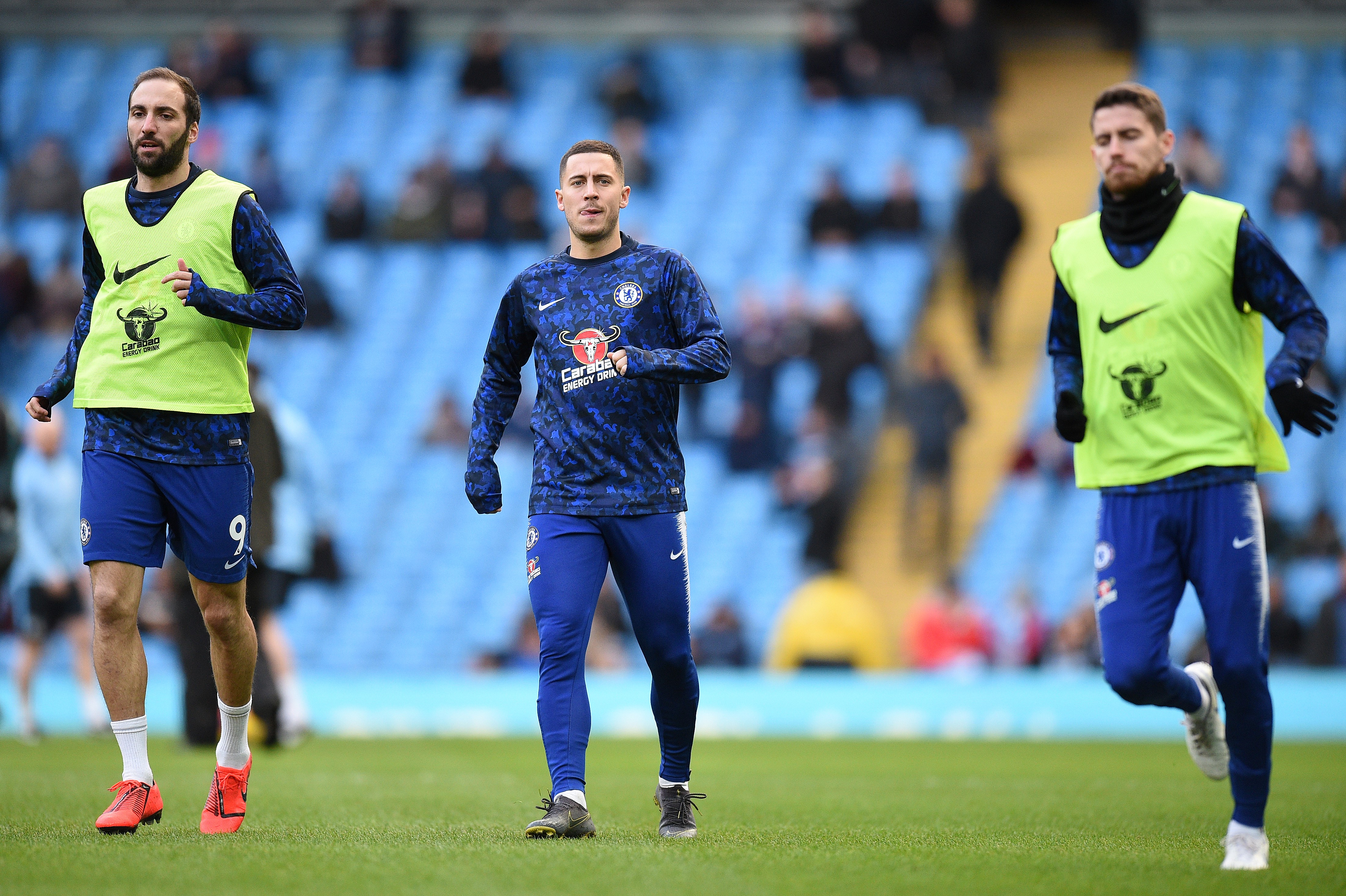 Chelsea's Argentinian striker Gonzalo Higuain (L) and Chelsea's Belgian midfielder Eden Hazard (C) warms up ahead of  the English Premier League football match between Manchester City and Chelsea at the Etihad Stadium in Manchester, north west England, on February 10, 2019. (Photo by Oli SCARFF / AFP) / RESTRICTED TO EDITORIAL USE. No use with unauthorized audio, video, data, fixture lists, club/league logos or 'live' services. Online in-match use limited to 120 images. An additional 40 images may be used in extra time. No video emulation. Social media in-match use limited to 120 images. An additional 40 images may be used in extra time. No use in betting publications, games or single club/league/player publications. /         (Photo credit should read OLI SCARFF/AFP/Getty Images)