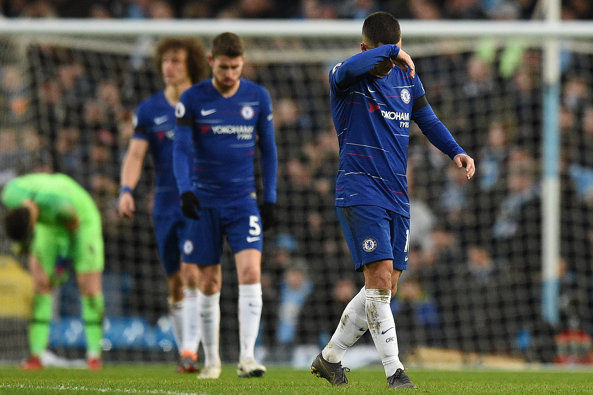 Chelsea's Belgian midfielder Eden Hazard (R) reacts after Manchester City's Argentinian striker Sergio Aguero scored from the penalty spot during the English Premier League football match between Manchester City and Chelsea at the Etihad Stadium in Manchester, north west England, on February 10, 2019. (Photo by Oli SCARFF / AFP) / RESTRICTED TO EDITORIAL USE. No use with unauthorized audio, video, data, fixture lists, club/league logos or 'live' services. Online in-match use limited to 120 images. An additional 40 images may be used in extra time. No video emulation. Social media in-match use limited to 120 images. An additional 40 images may be used in extra time. No use in betting publications, games or single club/league/player publications. /         (Photo credit should read OLI SCARFF/AFP/Getty Images)