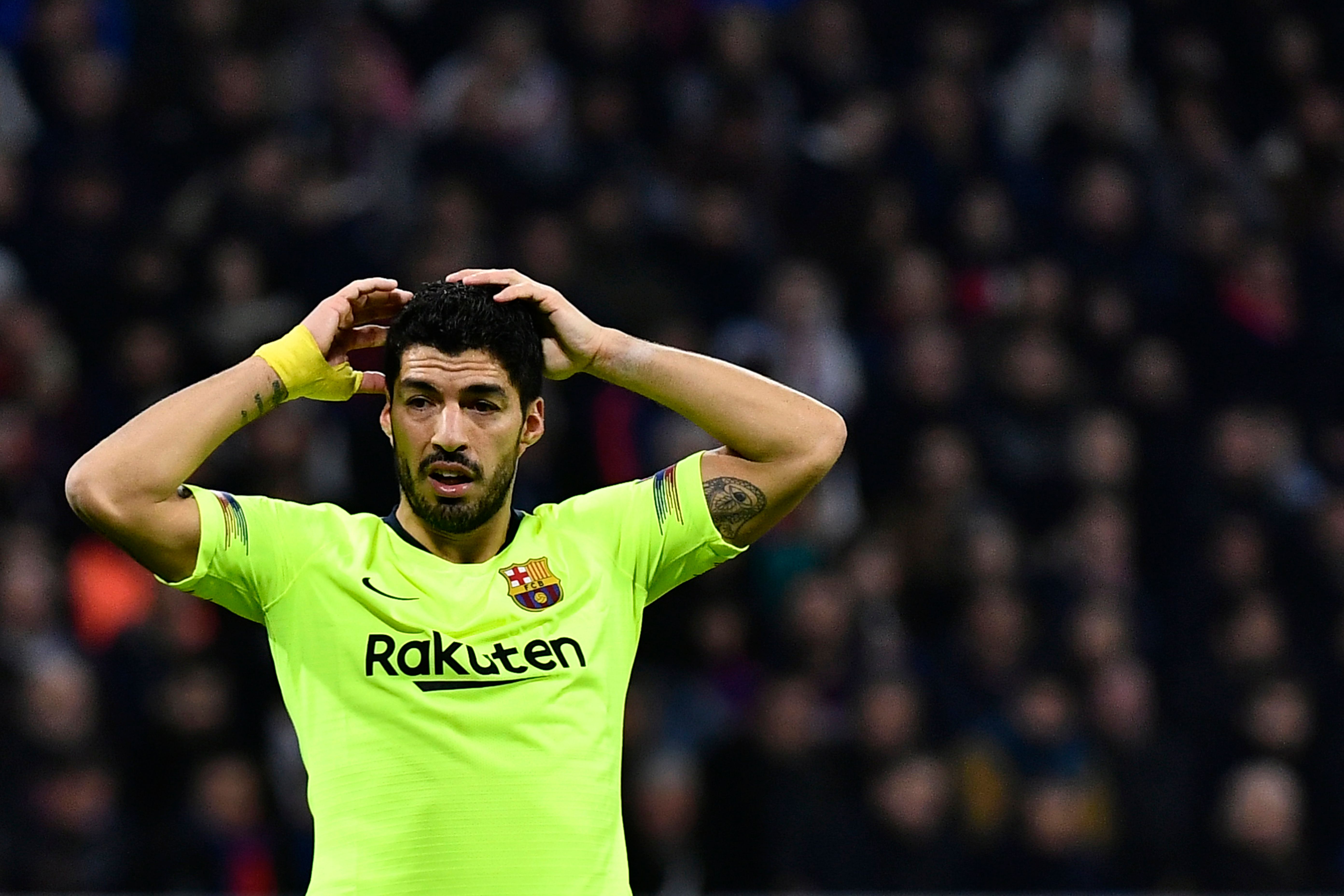 Barcelona's Uruguayan forward Luis Suarez reacts during the UEFA Champions League round of 16 first leg football match between Lyon (OL) and FC Barcelona on February 19, 2019, at the Groupama Stadium in Decines-Charpieu, central-eastern France. (Photo by JEFF PACHOUD / AFP)        (Photo credit should read JEFF PACHOUD/AFP/Getty Images)