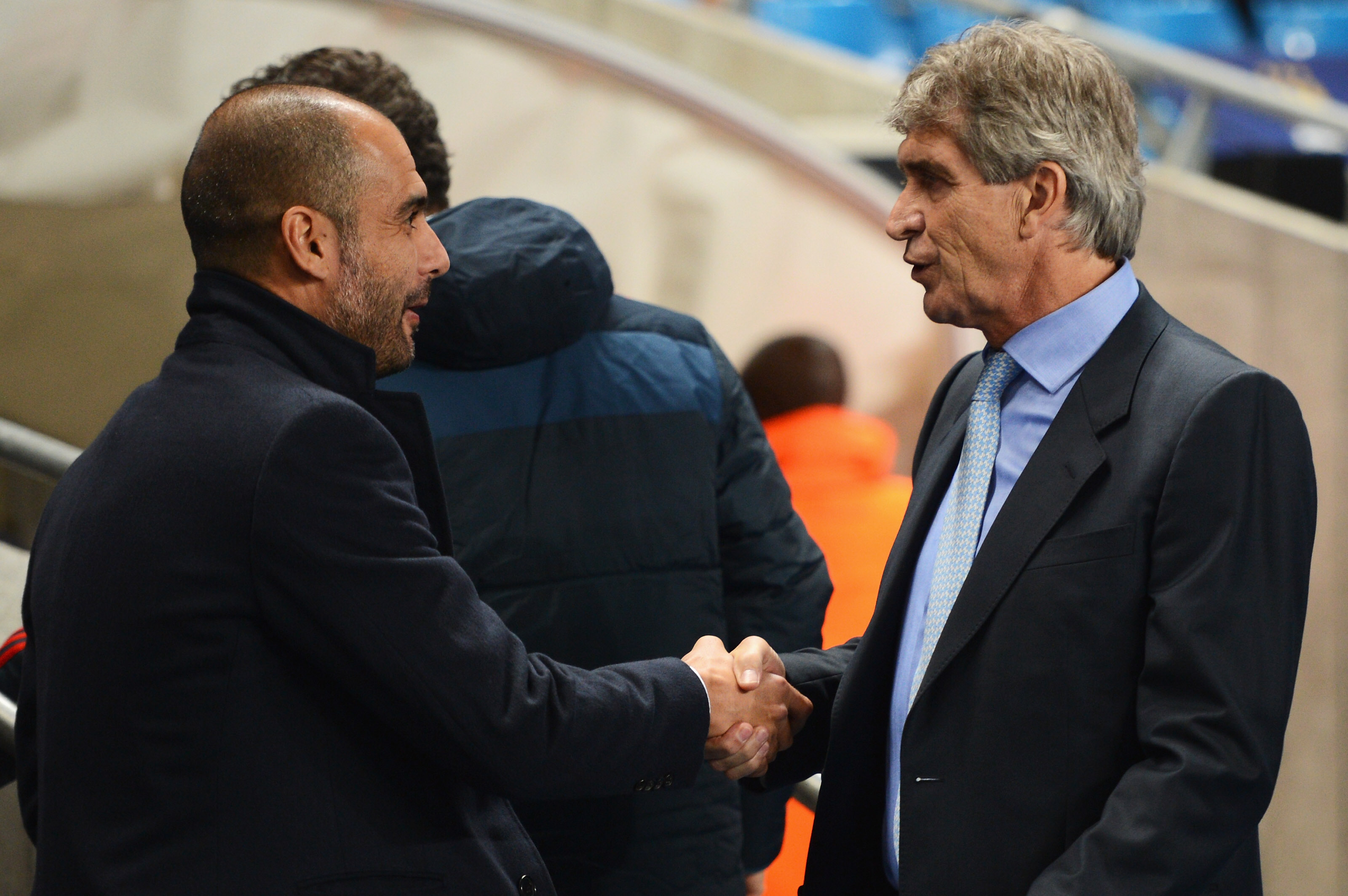 MANCHESTER, ENGLAND - OCTOBER 02:  Manuel Pellegrini (R), coach of Manchester City greets Josep Guardiola, coach of Muenchen during the UEFA Champions League Group D match between Manchester City and FC Bayern Muenchen at Etihad Stadium on October 2, 2013 in Manchester, England.  (Photo by Michael Regan/Bongarts/Getty Images)