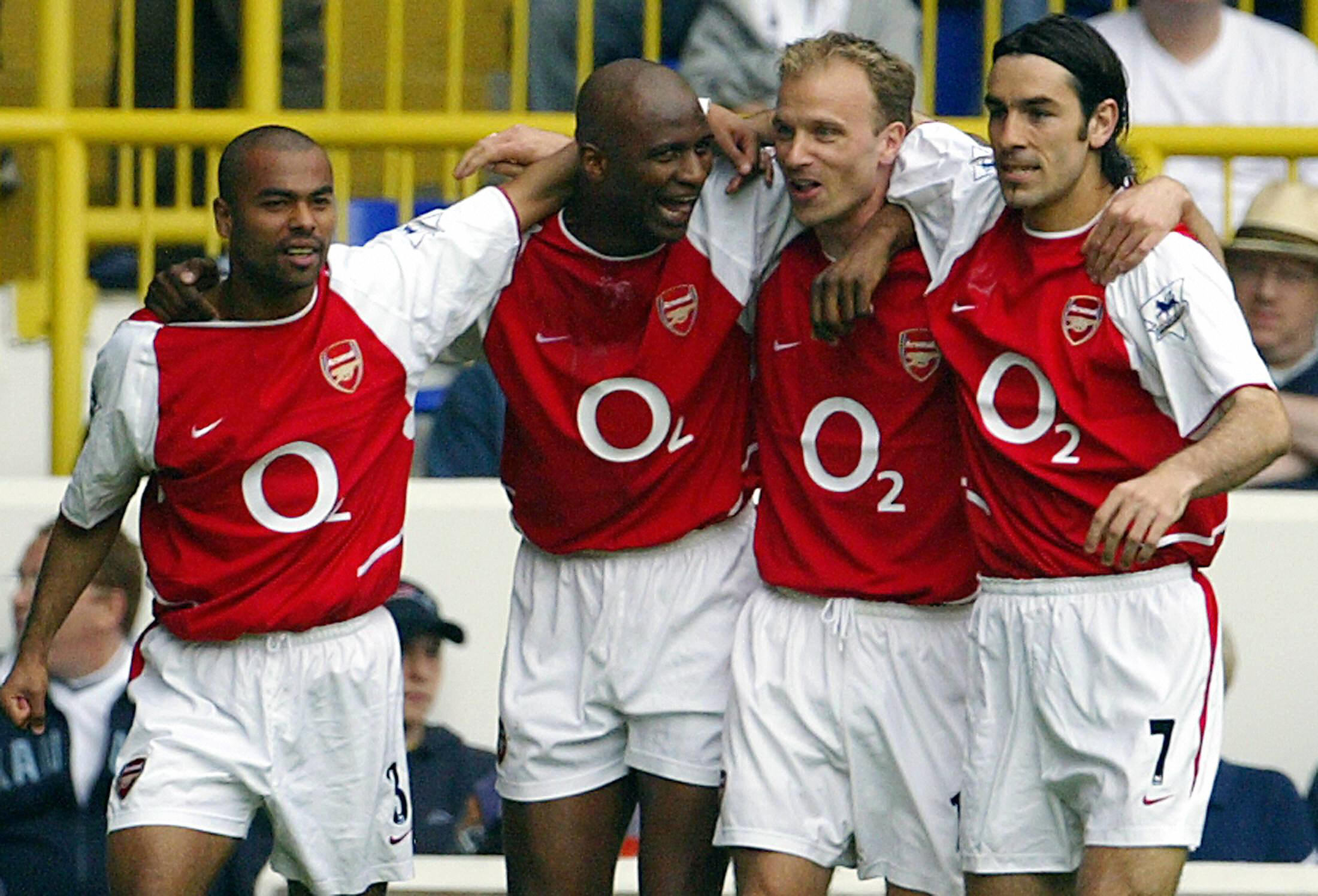 LONDON, UNITED KINGDOM:  Arsenal's French captain Patrick Vieira (2ndL) celebrates his goal against Tottenham with teammates Ashley Cole (L), Dennis Bergkamp (2ndR) and Robert Pires (R) during their Premier League football match at White Hart Lane in north London, 25 April 2004.  AFP PHOTO / ODD ANDERSEN     - - No telcos,website use to description of license with FAPL on, www.faplweb.com - -  (Photo credit should read ODD ANDERSEN/AFP/Getty Images)