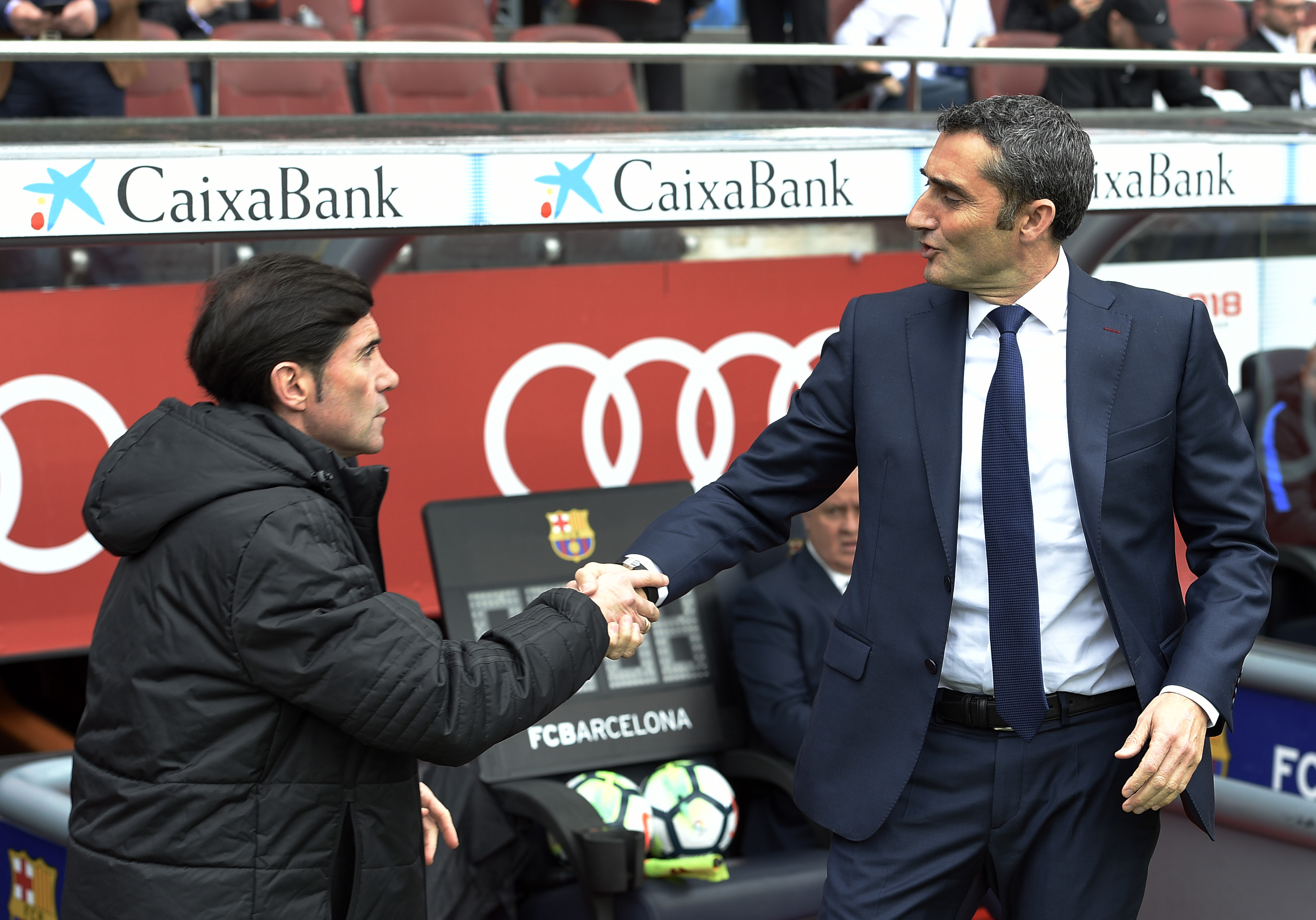 Barcelona's Spanish coach Ernesto Valverde (R) shakes hands with Valencia's Spanish coach Marcelino Garcia Toral during the Spanish league footbal match between FC Barcelona and Valencia CF at the Camp Nou stadium in Barcelona on April 14, 2018. / AFP PHOTO / LLUIS GENE        (Photo credit should read LLUIS GENE/AFP/Getty Images)