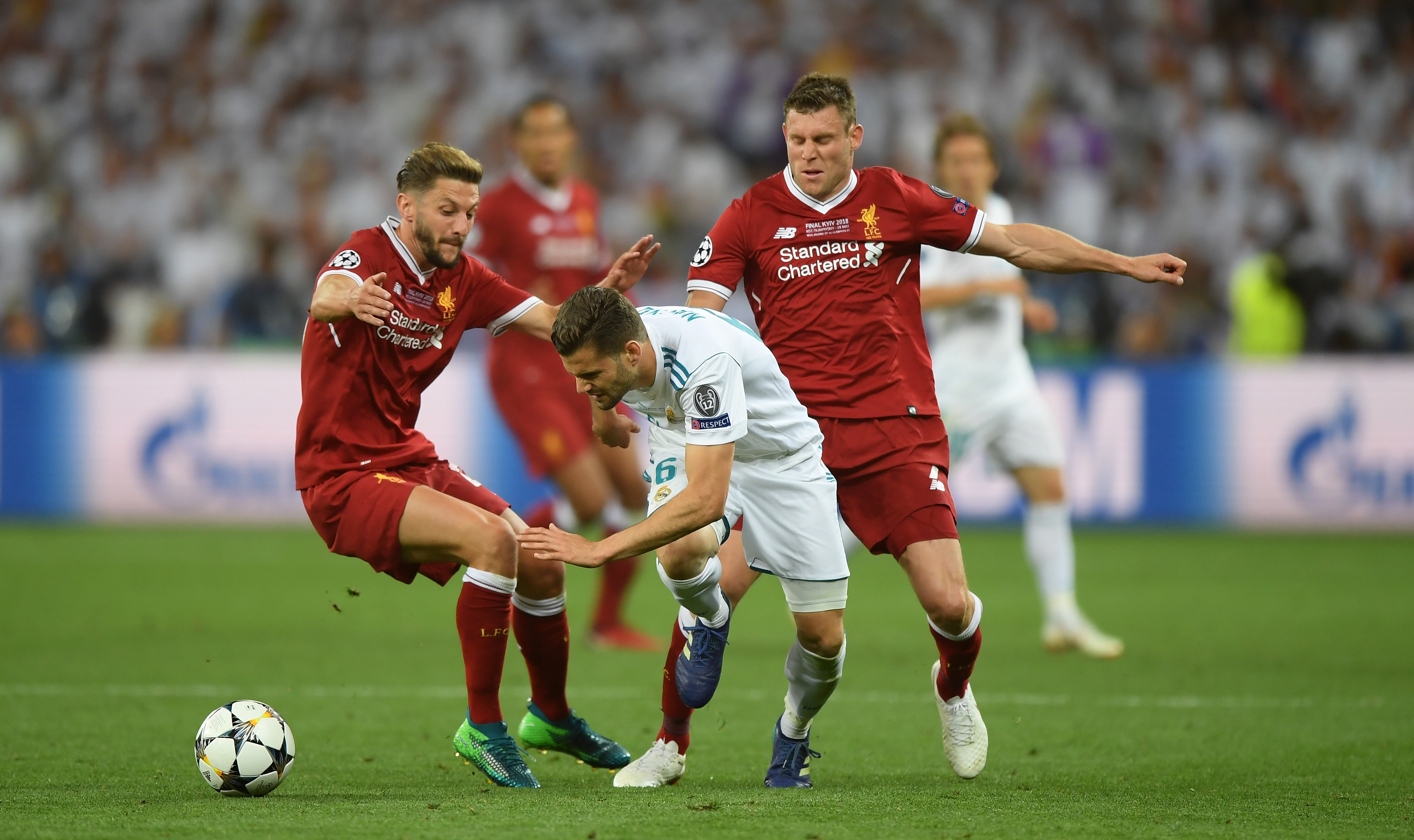 KIEV, UKRAINE - MAY 26:  Nacho Fernandez of Real Madrid, James Milner and Adam Lallana of Liverpool compete for the ball during the UEFA Champions League Final between Real Madrid and Liverpool at NSC Olimpiyskiy Stadium on May 26, 2018 in Kiev, Ukraine.  (Photo by Shaun Botterill/Getty Images)