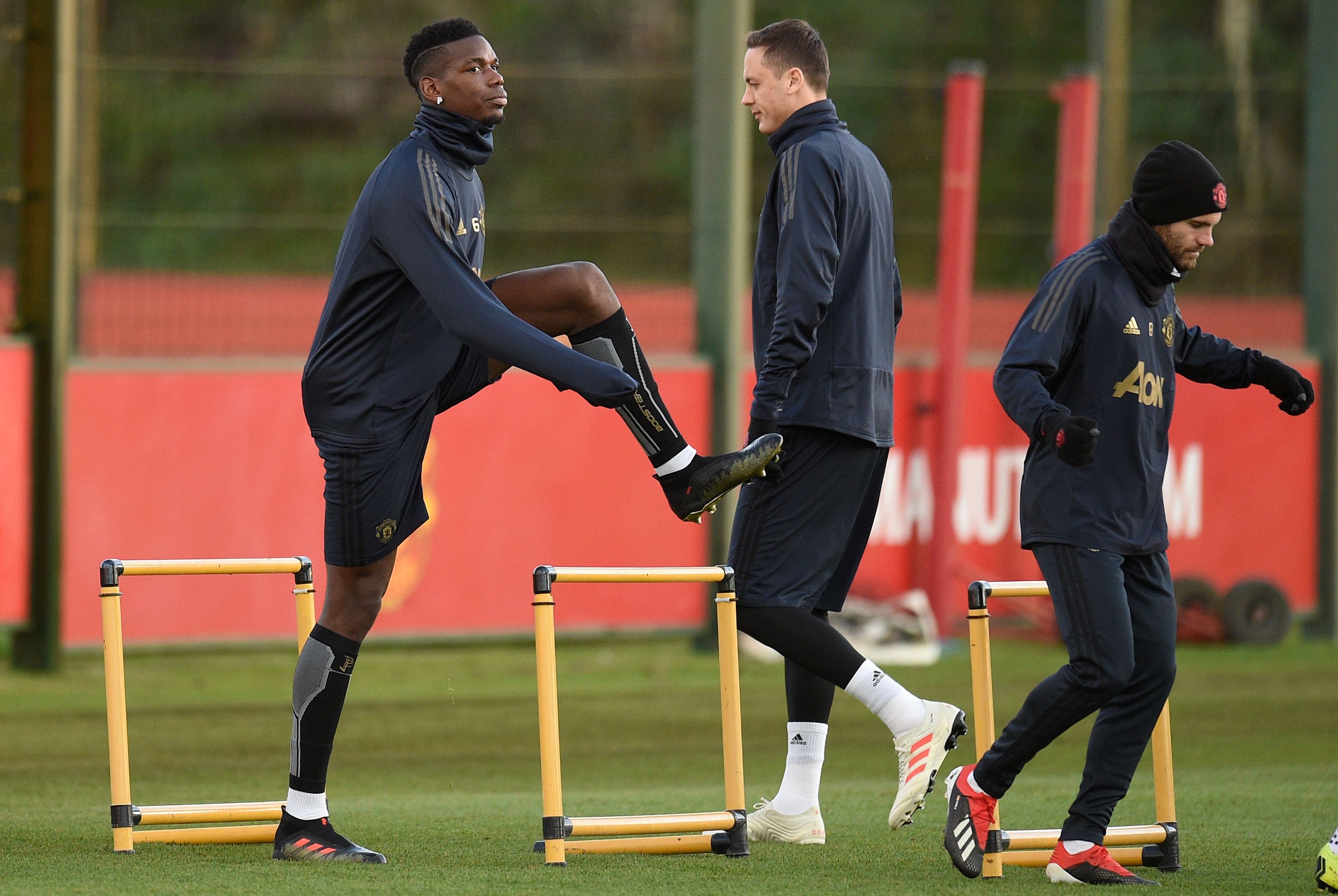Manchester United's French midfielder Paul Pogba (L), Manchester United's Serbian midfielder Nemanja Matic (C) and Manchester United's Spanish midfielder Juan Mata attend a training session at the Carrington Training complex in Manchester, north west England on November 26, 2018, on the eve of their UEFA Champions League group H football match against Young Boys. (Photo by Oli SCARFF / AFP)        (Photo credit should read OLI SCARFF/AFP/Getty Images)