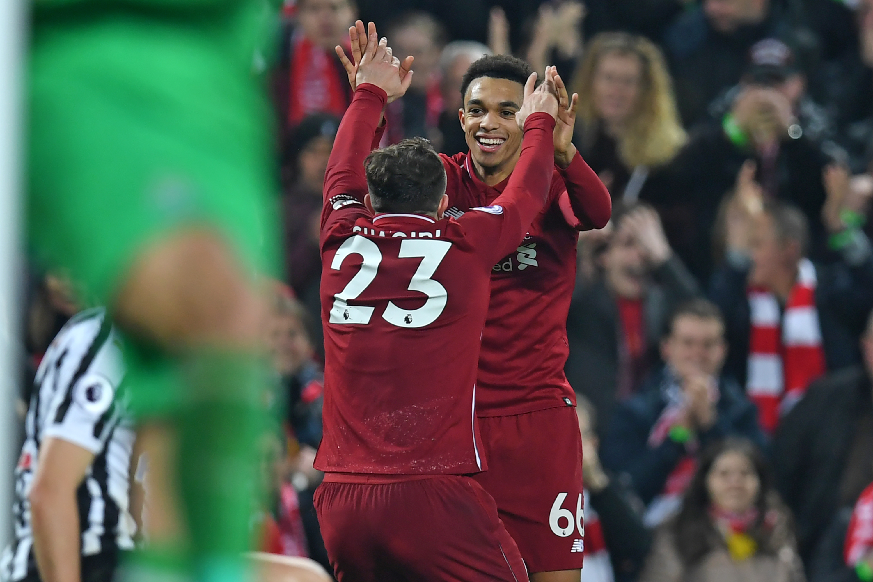 Liverpool's Swiss midfielder Xherdan Shaqiri (L) celebrates with Liverpool's English defender Trent Alexander-Arnold (R) after scoring their third goal during the English Premier League football match between Liverpool and Newcastle United at Anfield in Liverpool, north west England on December 26, 2018. - Liverpool won the game 4-0. (Photo by Paul ELLIS / AFP) / RESTRICTED TO EDITORIAL USE. No use with unauthorized audio, video, data, fixture lists, club/league logos or 'live' services. Online in-match use limited to 120 images. An additional 40 images may be used in extra time. No video emulation. Social media in-match use limited to 120 images. An additional 40 images may be used in extra time. No use in betting publications, games or single club/league/player publications. /         (Photo credit should read PAUL ELLIS/AFP/Getty Images)