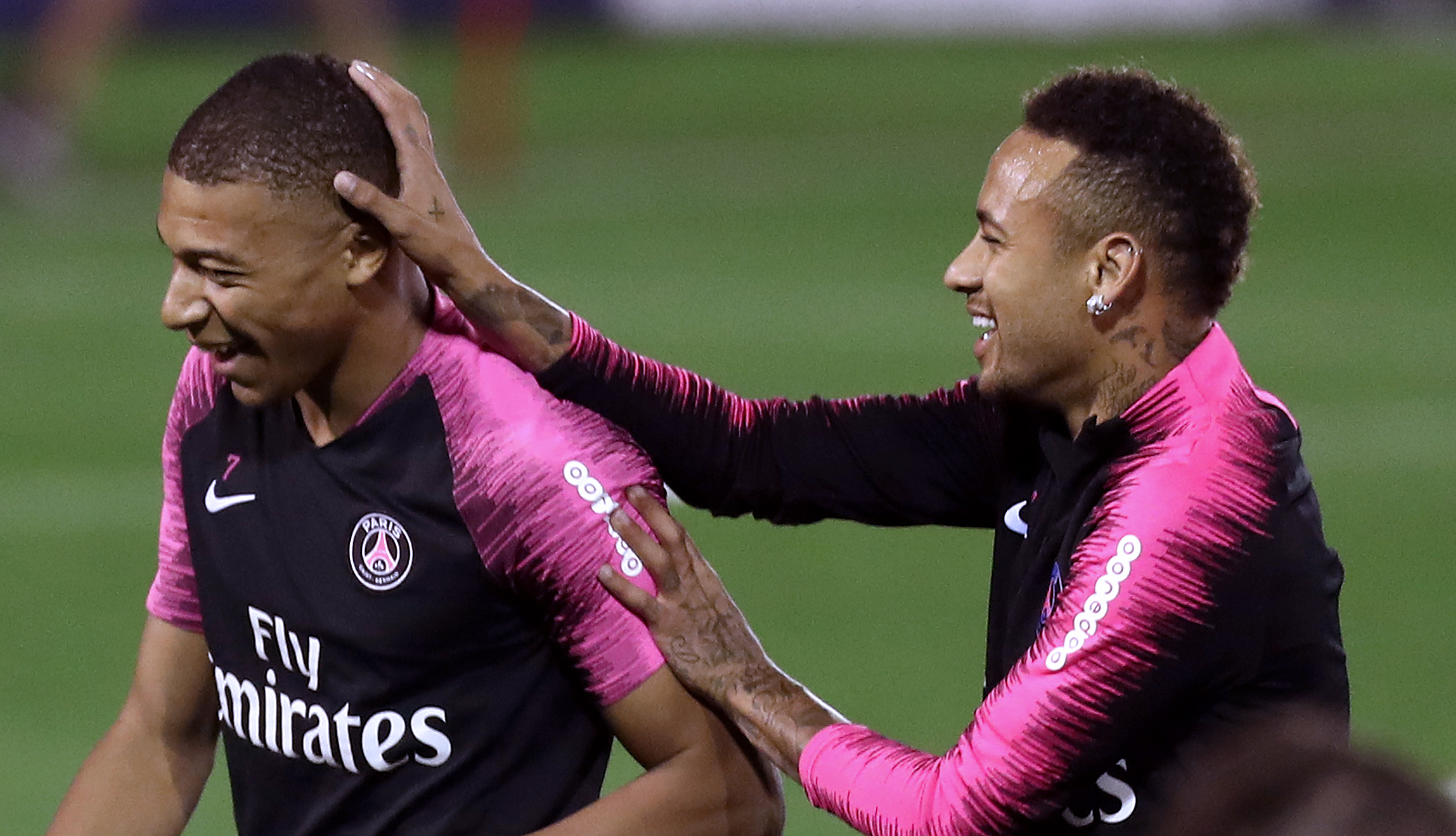 Paris Saint-Germain's French forward Kylian Mbappe (L) and Paris Saint-Germain's Brazilian forward Neymar share a light moment during the team's winter training camp at the Khalifa International Stadium in the Qatari capital Doha on January 16, 2019. (Photo by KARIM JAAFAR / AFP)        (Photo credit should read KARIM JAAFAR/AFP/Getty Images)