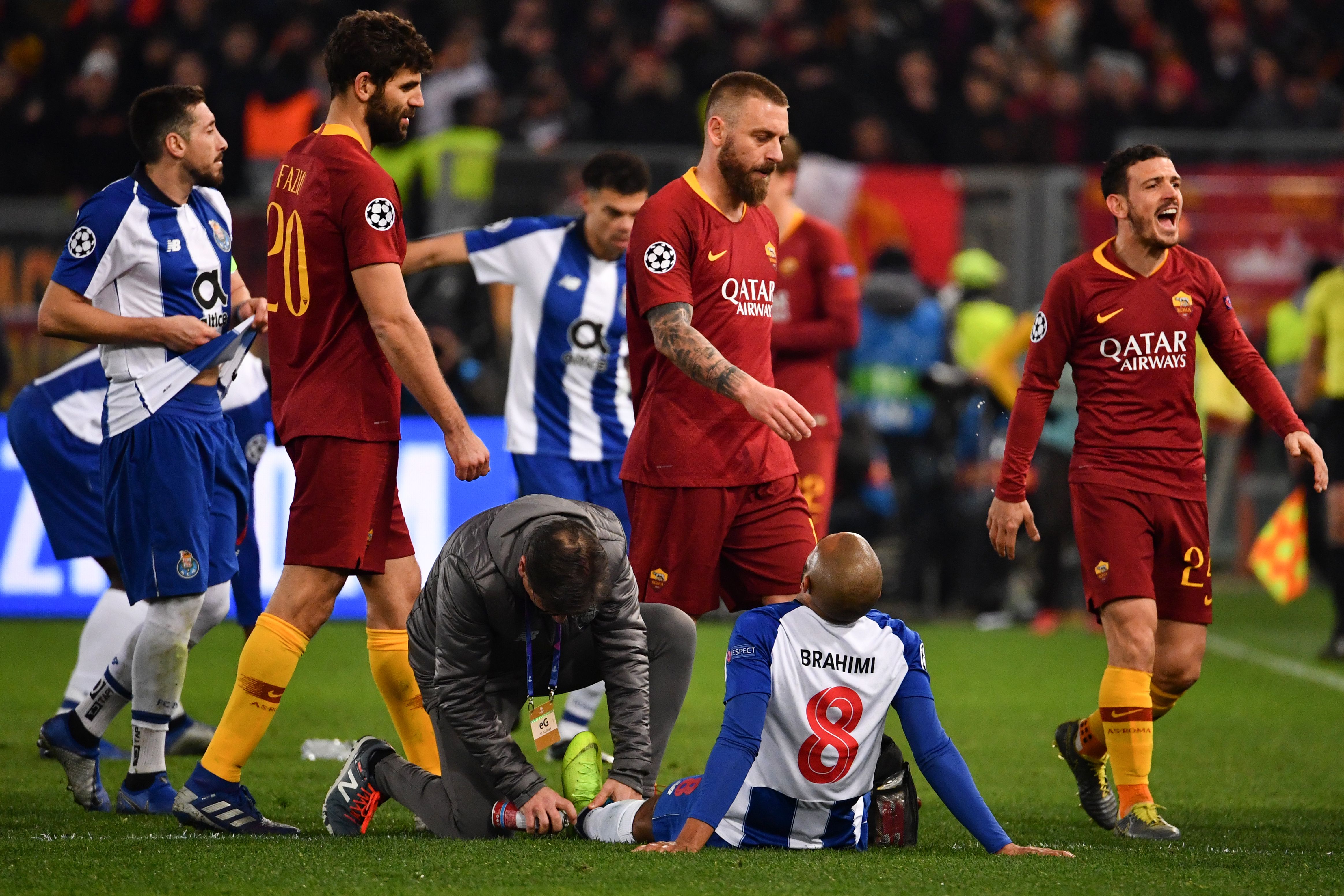 Porto's Algerian midfielder Yacine Brahimi (Bottom R) is being treated for injury during the UEFA Champions League round of 16, first leg football match AS Roma vs FC Porto on February 12, 2019 at the Olympic stadium in Rome. (Photo by Alberto PIZZOLI / AFP)        (Photo credit should read ALBERTO PIZZOLI/AFP/Getty Images)