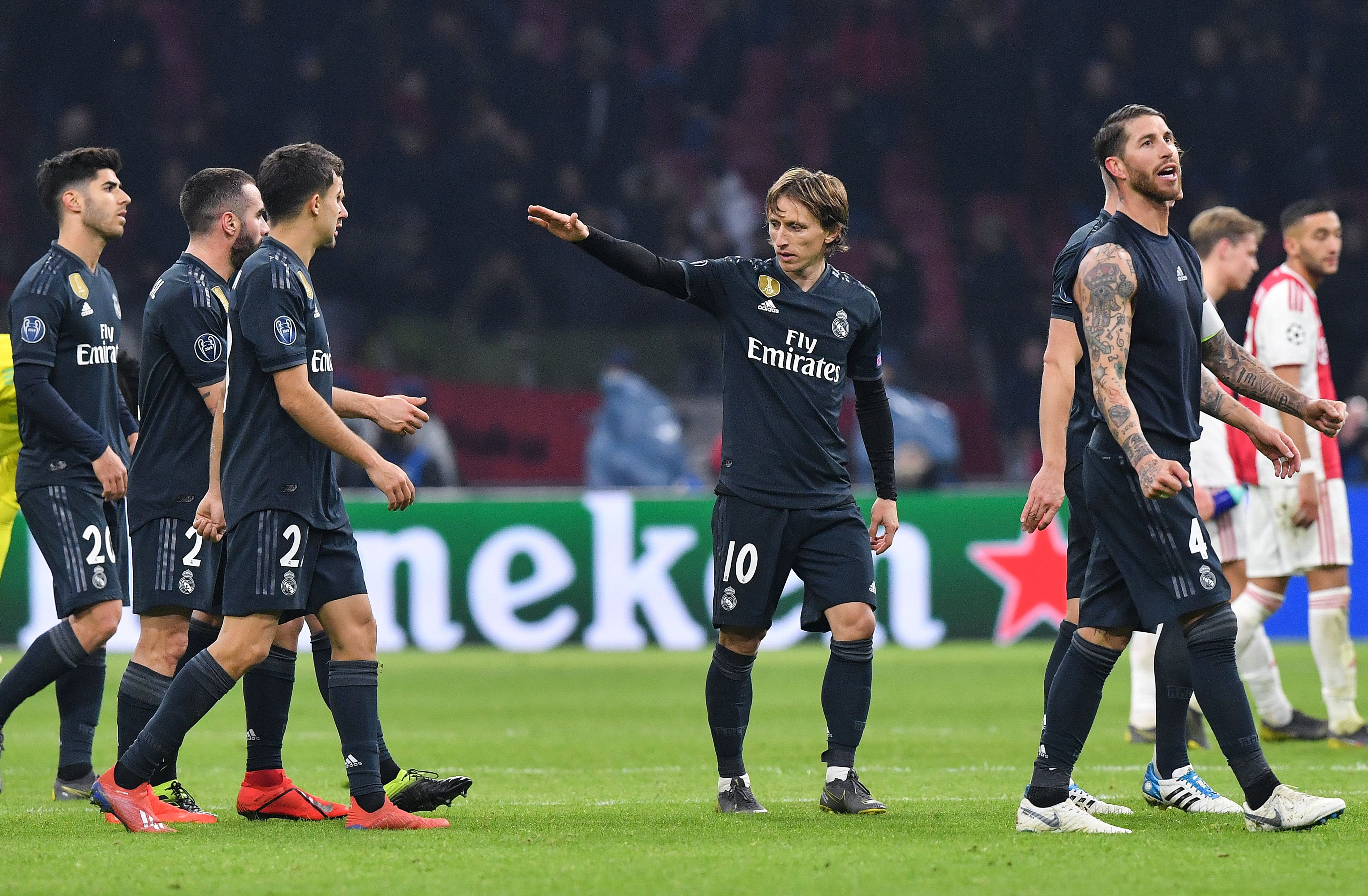 Real Madrid's Luka Modric (C) celebrates with teammates during the UEFA Champions league round of 16 first leg football match between Ajax Amsterdam and Real Madrid at the Johan Cruijff ArenA on February 13, 2019. (Photo by EMMANUEL DUNAND / AFP)        (Photo credit should read EMMANUEL DUNAND/AFP/Getty Images)