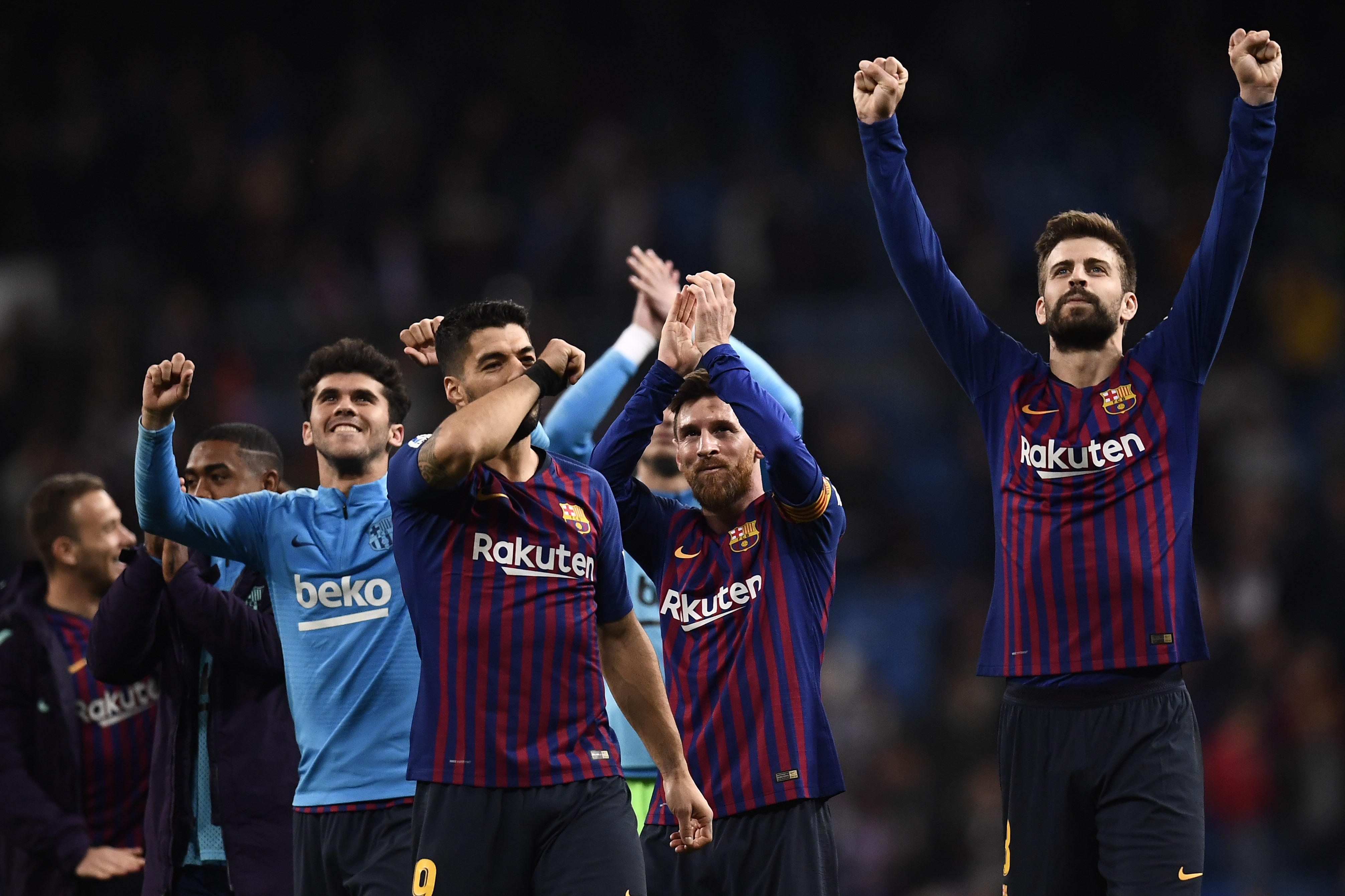 Barcelona's Uruguayan forward Luis Suarez (3R), Barcelona's Argentinian forward Lionel Messi (2R) and Barcelona's Spanish defender Gerard Pique (R) celebrate their win at the end of the Spanish league football match between Real Madrid CF and FC Barcelona at the Santiago Bernabeu stadium in Madrid on March 2, 2019. (Photo by OSCAR DEL POZO / AFP)        (Photo credit should read OSCAR DEL POZO/AFP/Getty Images)